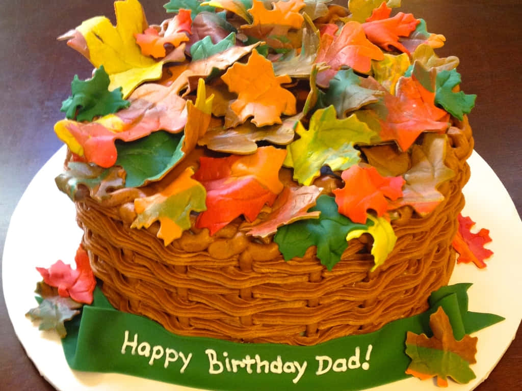 生日蛋糕，裝飾有秋葉和一條寫著Happy Birthday Dad的綠色絲帶
