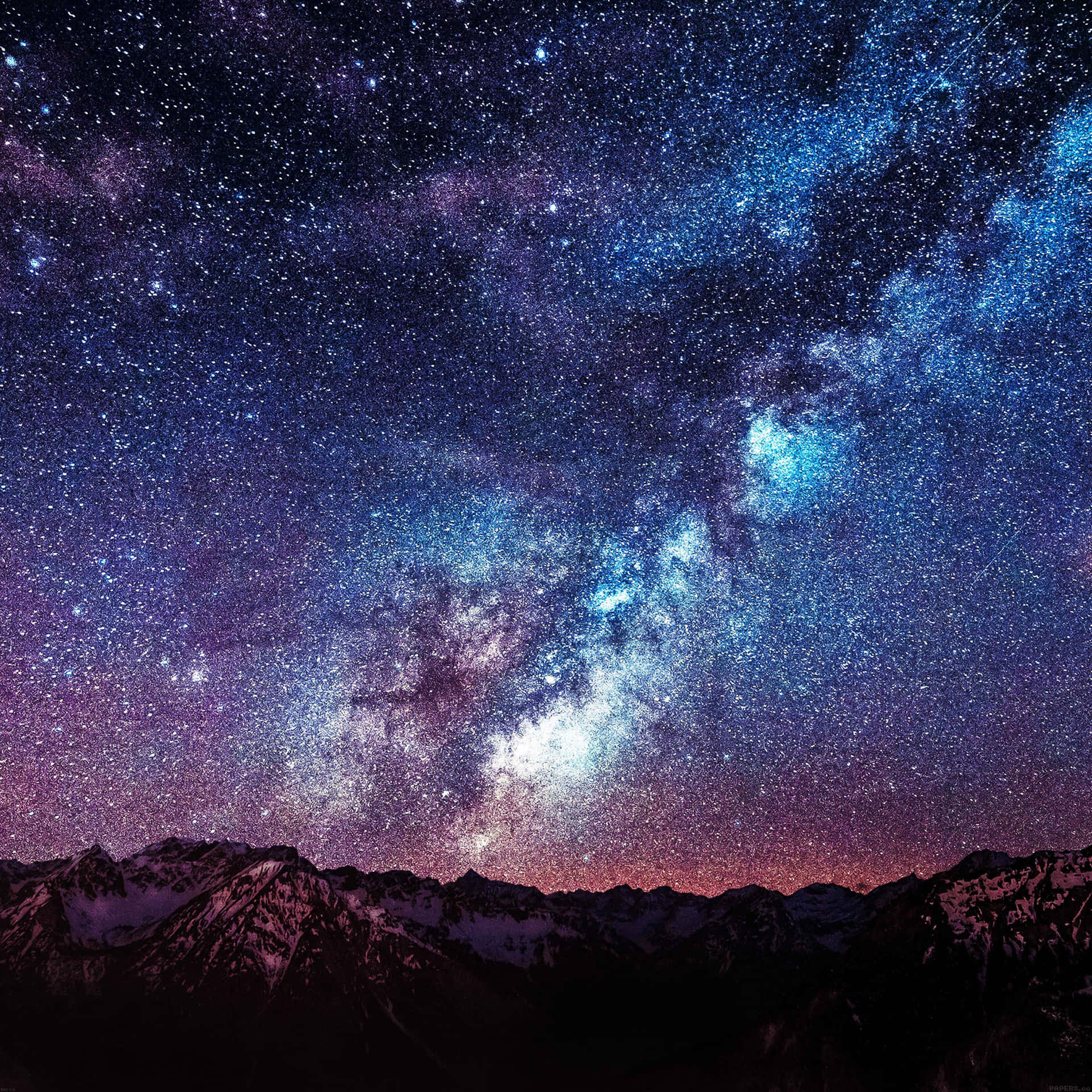 在星空夜空下，積雪的山脈，銀河系清晰可見。