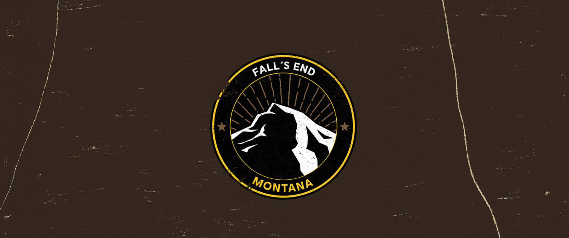 圓形標誌，帶有山脈輪廓和文字 Fall's End Montana，背景為紋理棕色。