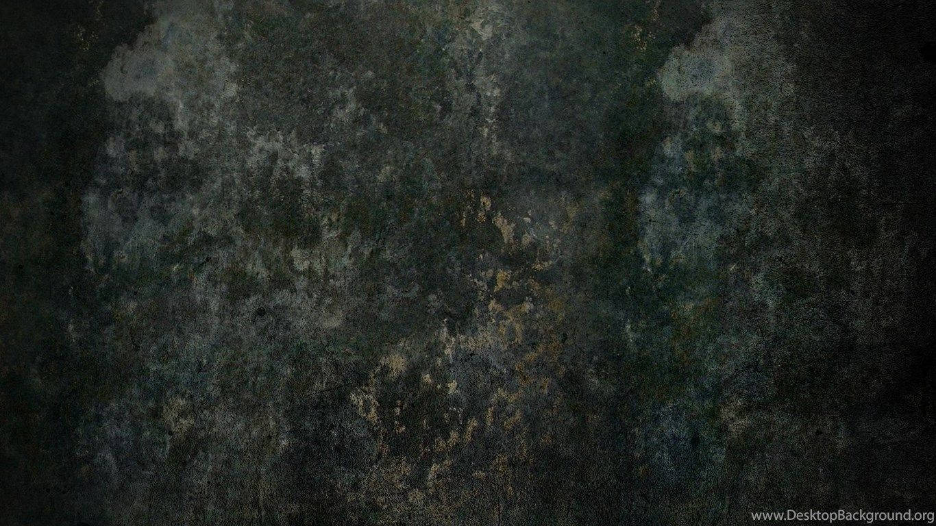 深色紋理表面，帶有斑駁的灰藍色和金色斑塊。