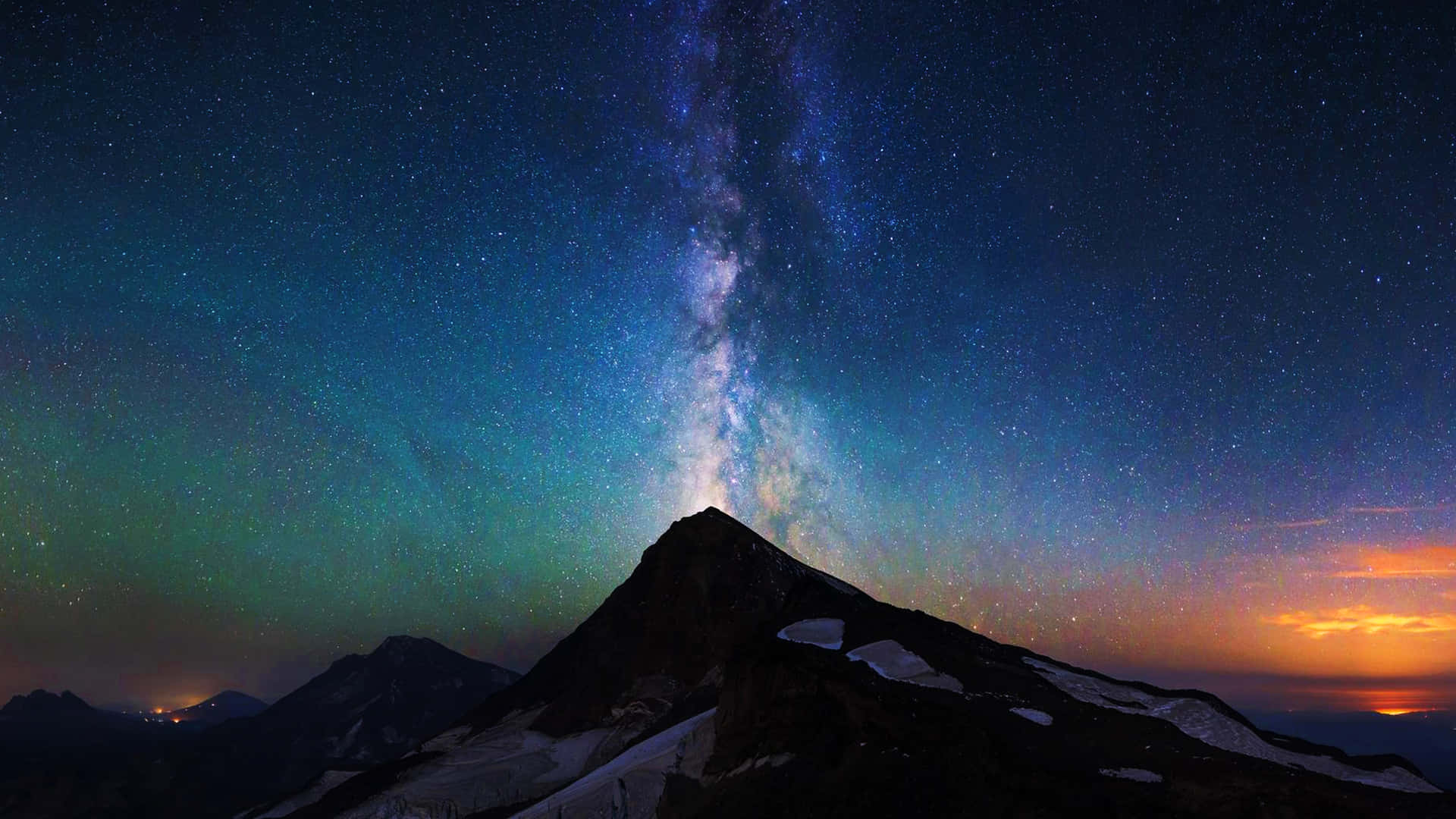山峰在星空下，有銀河和極光
