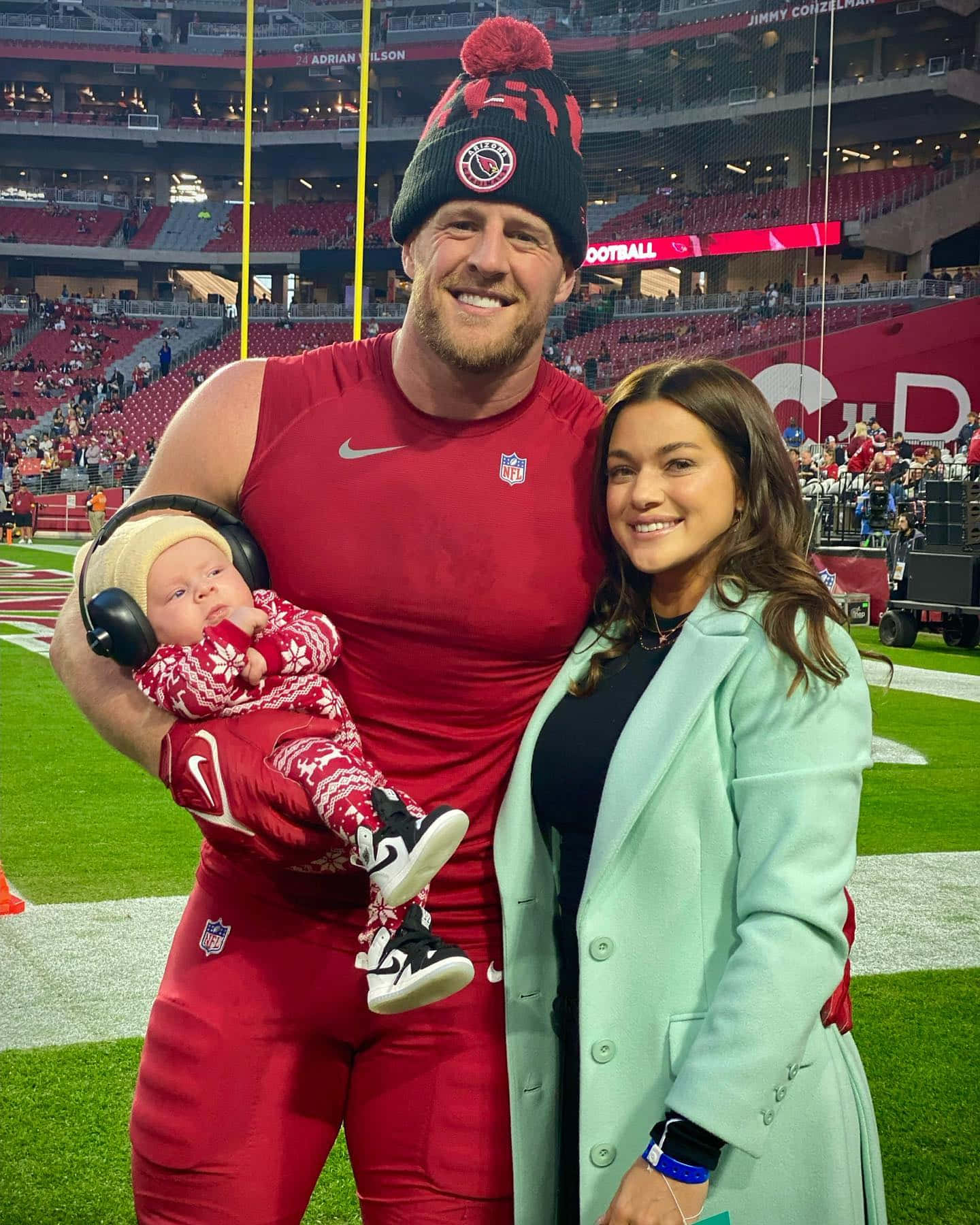 NFL球員與妻子和嬰兒在夜晚的足球場上