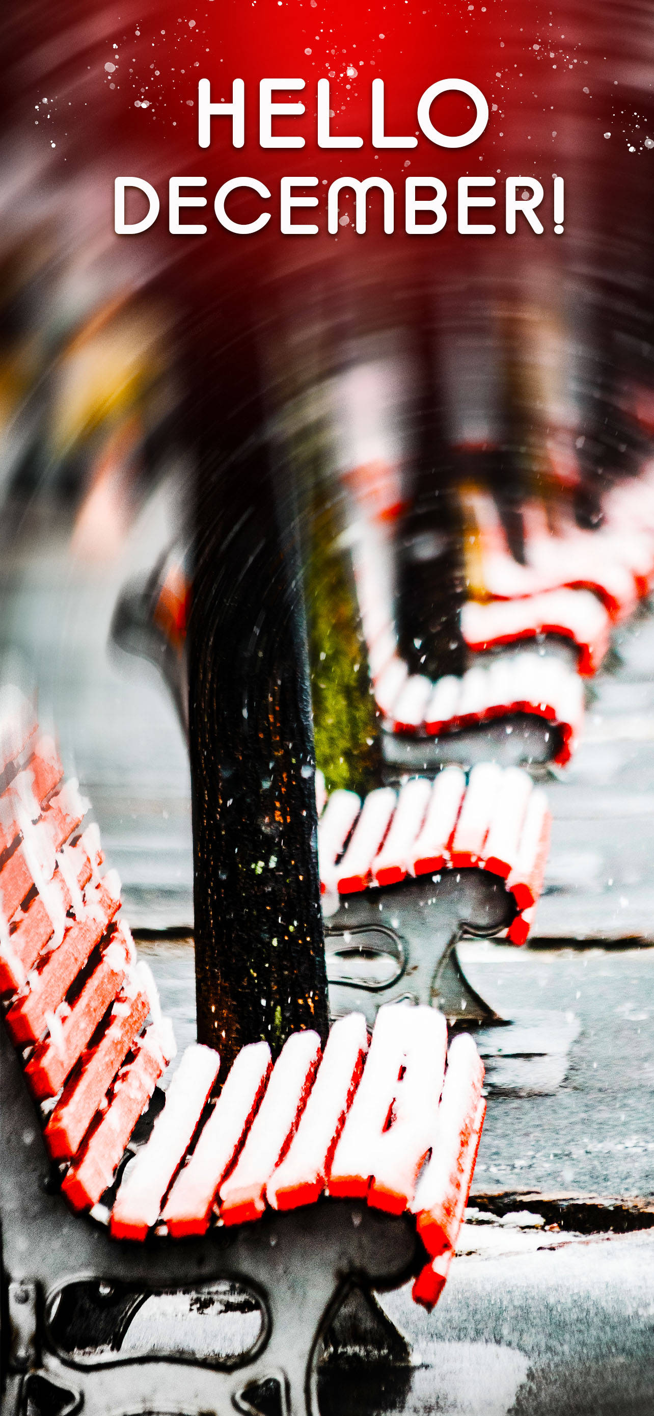 你好十二月雪季 壁紙 — 雪花飄過一排紅色長椅，冬日城市場景，粗體文字寫著 hello december