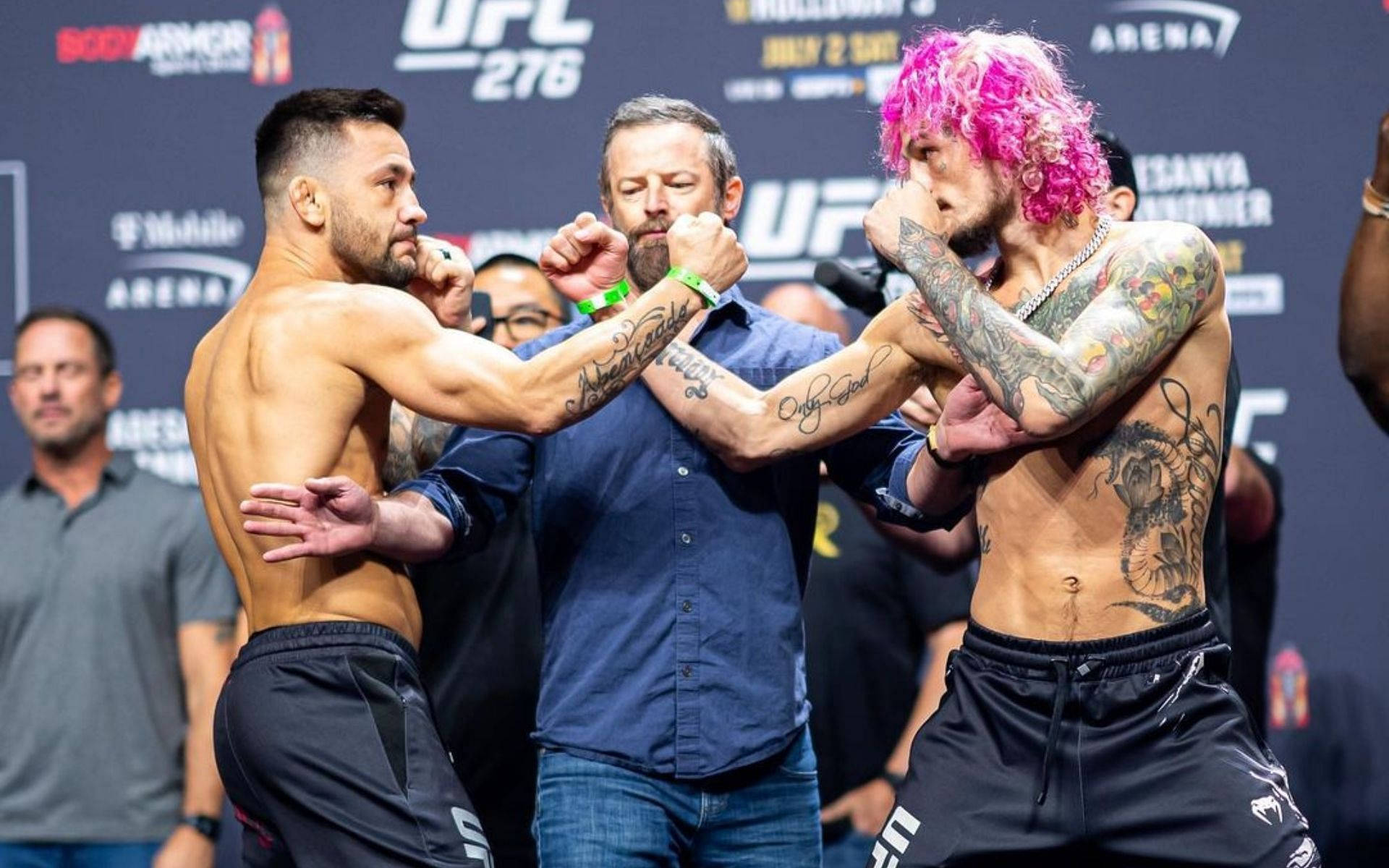 兩名男性MMA拳手在UFC稱重活動中擺出戰鬥姿勢。
