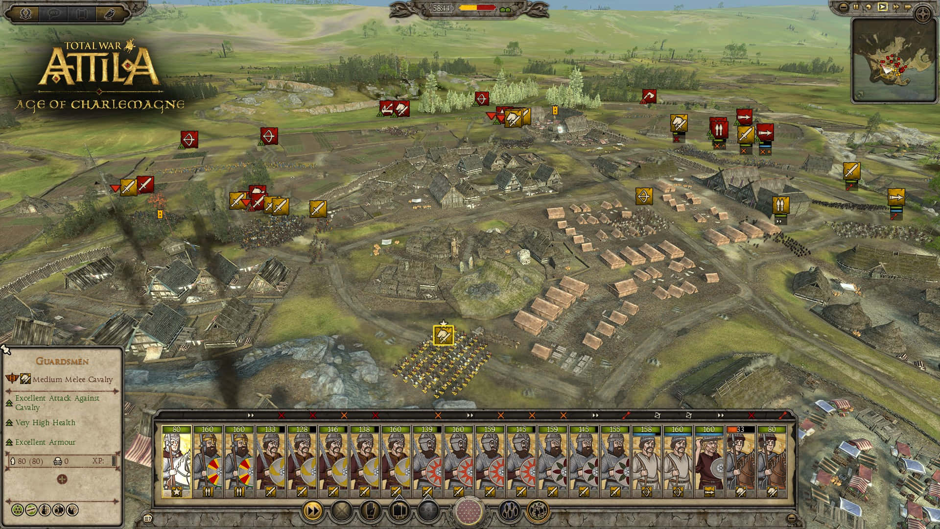 全軍破敵：阿提拉 桌布 壁紙 — 來自《Total War Attila》的戰略戰場視角，顯示中世紀軍隊圍繞一個設防村莊佈陣，並帶有UI元素。