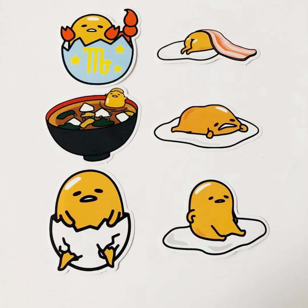 一套六張 Gudetama 貼紙，展示懶惰蛋角色在不同場景中。