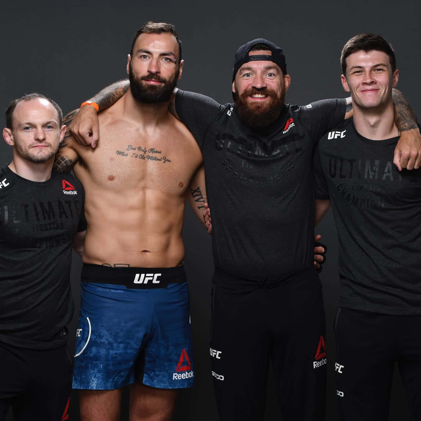四位男性UFC拳手穿著運動服一起擺姿勢，紋身清晰可見。