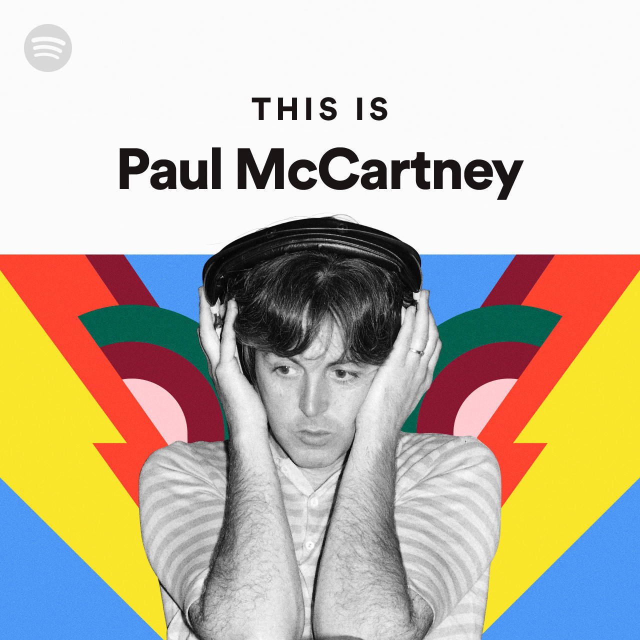 保羅·麥卡特尼這是Spotify 壁紙 — 保羅·麥卡尼以黑白影像，將耳機貼在耳邊，背景為充滿活力的幾何圖案。