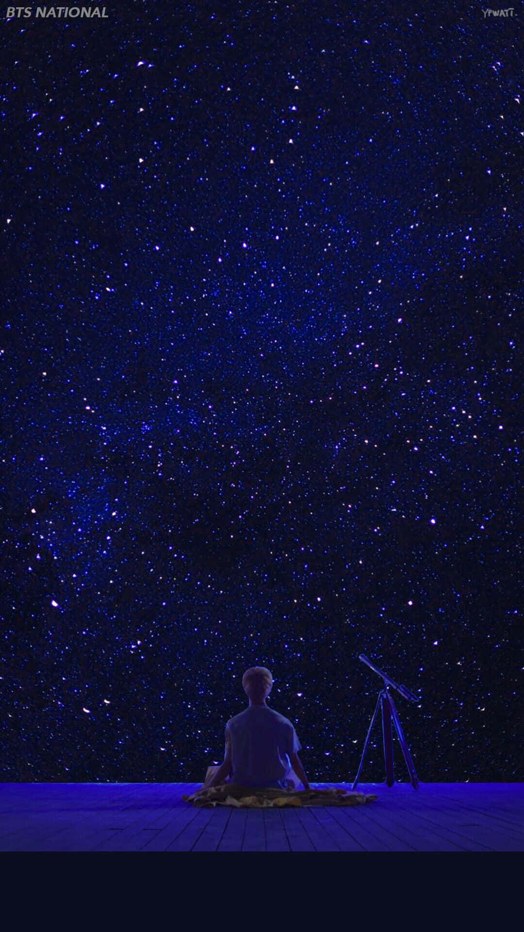 人坐在甲板上星空下與望遠鏡