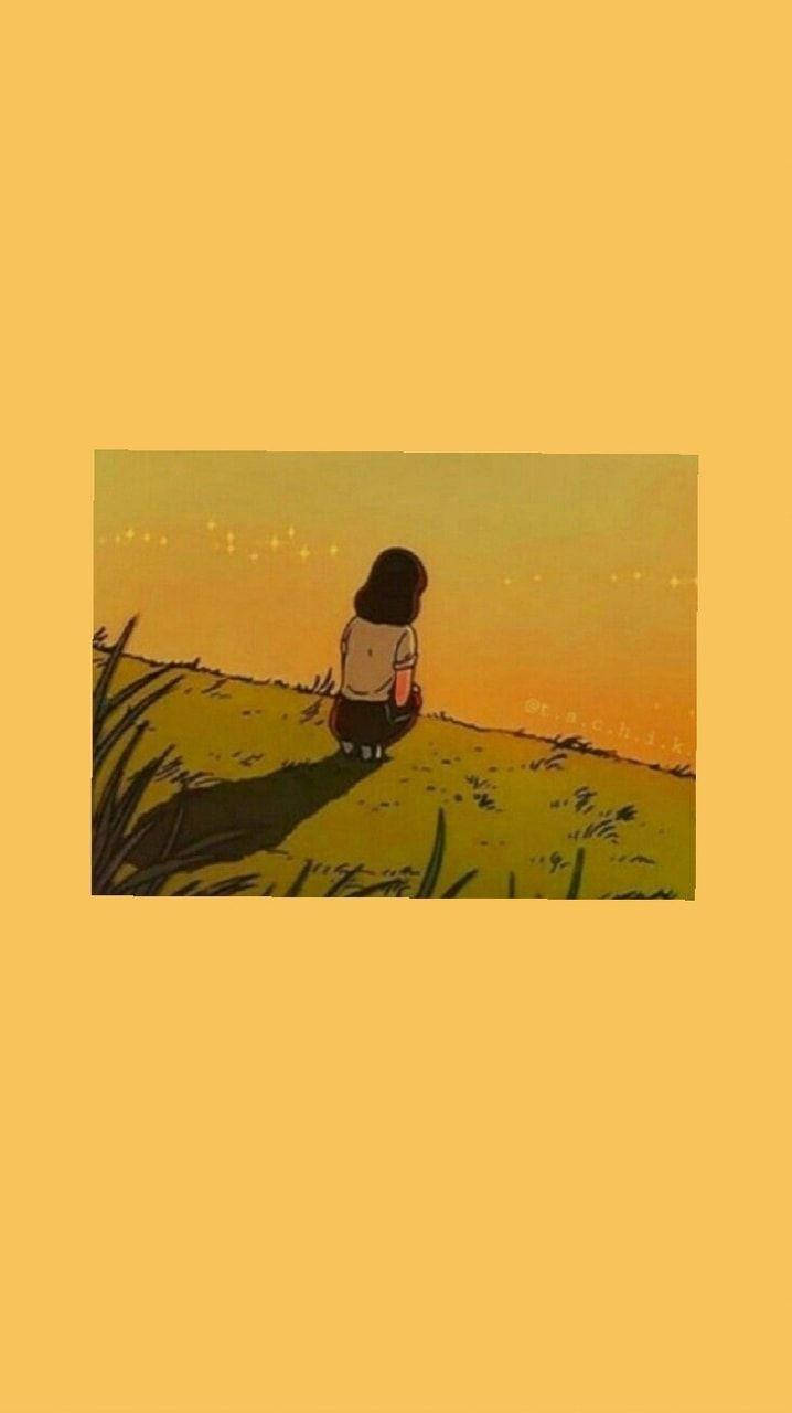 女孩獨自坐在草地上觀看日落。