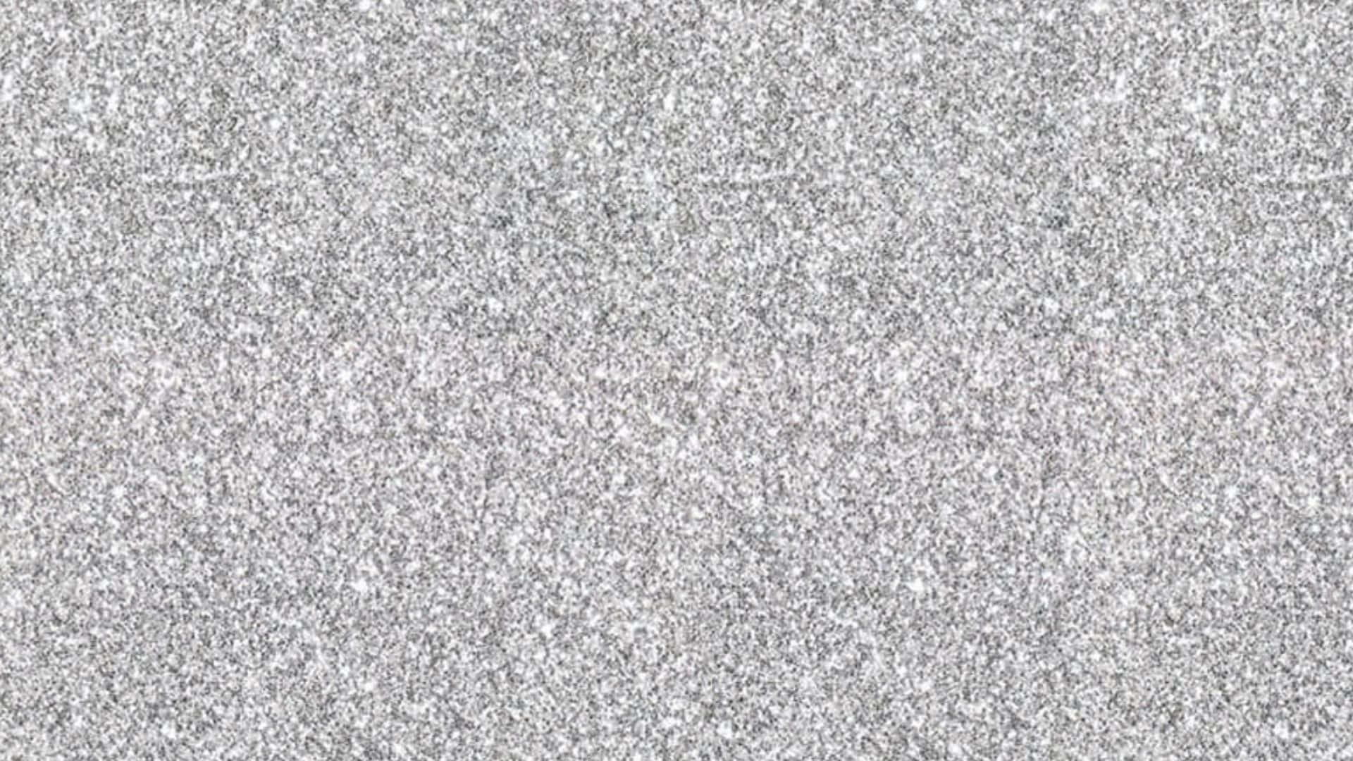 優雅高解析度金箔背景 壁紙 — 均勻光線下光滑灰色花崗岩表面的特寫，帶有白色和黑色礦物顆粒斑點。