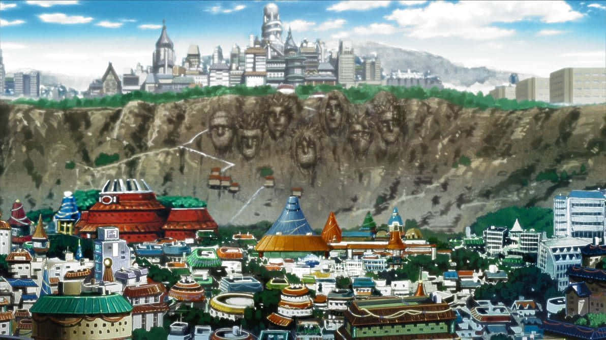 Naruto Village 桌布 壁紙 — 充滿活力的動漫城市景觀，色彩繽紛的建築物坐落在懸崖底部，懸崖上有巨大的雕刻面孔，在明亮的藍天下。