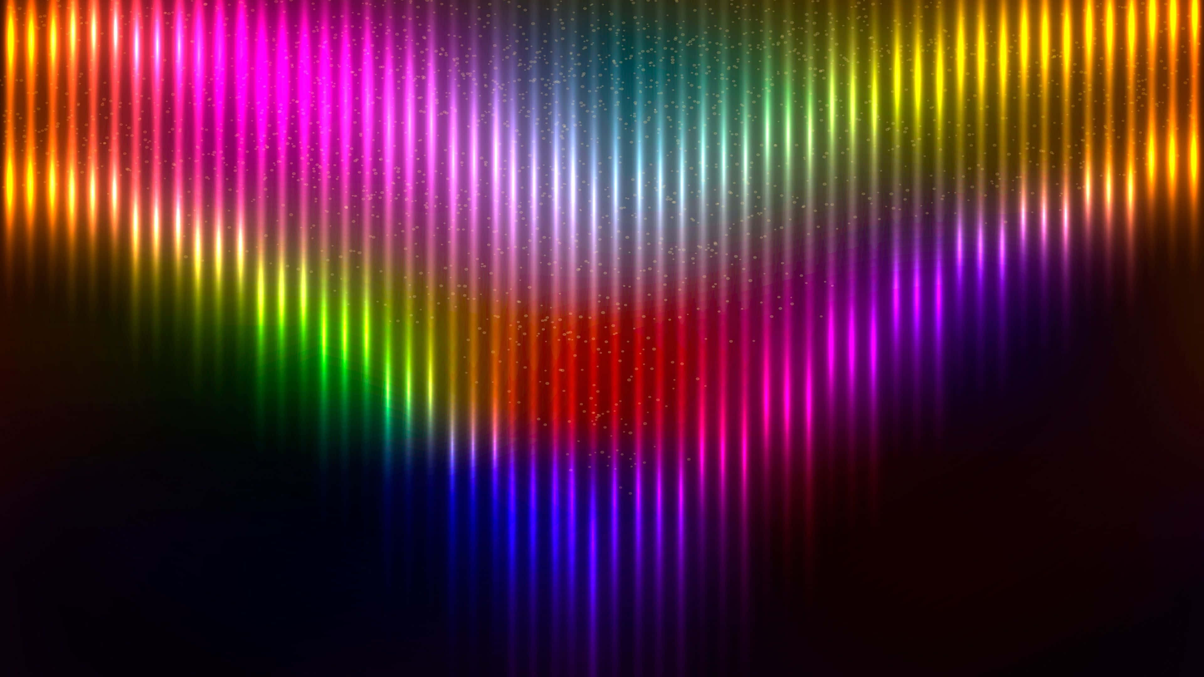 colors 桌布 壁紙 — 充滿活力的垂直彩虹光束在黑暗背景下脈動，閃爍著閃閃發光的粒子。