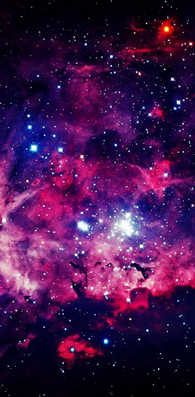 銀河 桌布 壁紙 — 充滿活力的宇宙星雲，帶有旋轉的粉紅色、紫色和藍色雲朵，點綴著明亮的星星，背景是黑暗的虛空。