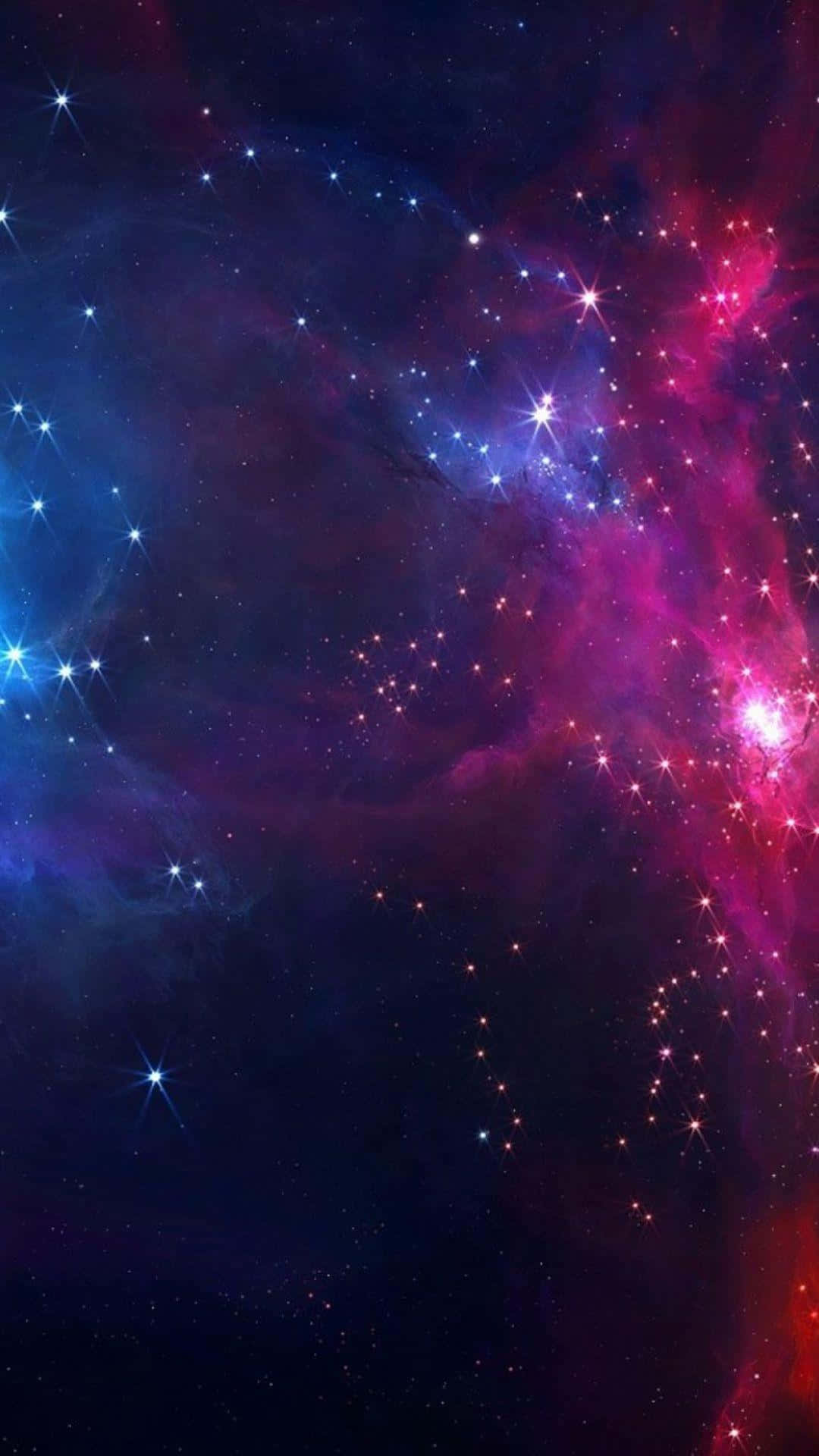 3d Galaxy 桌布 壁紙 — 充滿活力的宇宙星雲在電光粉紅和深藍色中旋轉，閃爍的星星點綴在黑暗的虛空中。