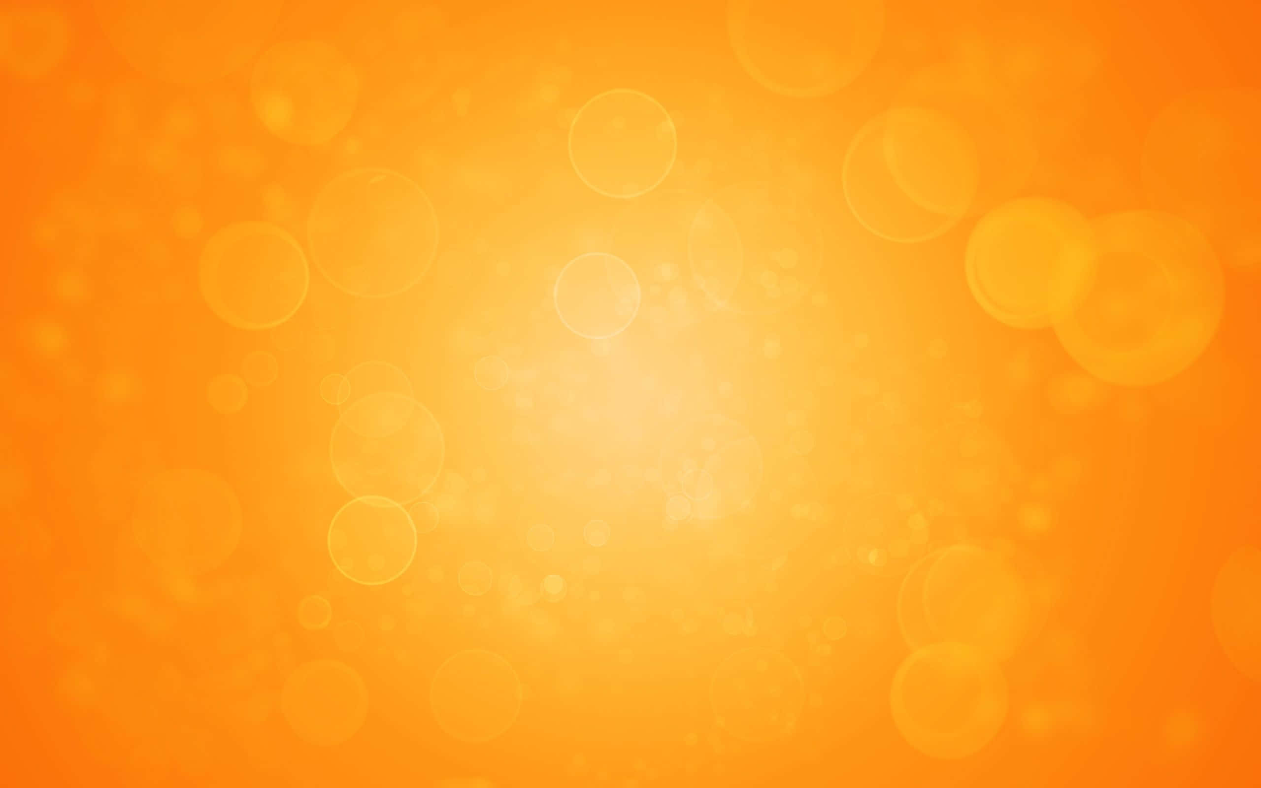 Orange And Yellow 桌布 壁紙 — 充滿活力的橙色漸變背景，帶有柔和發光的散景圓圈，營造溫暖夢幻的氛圍。