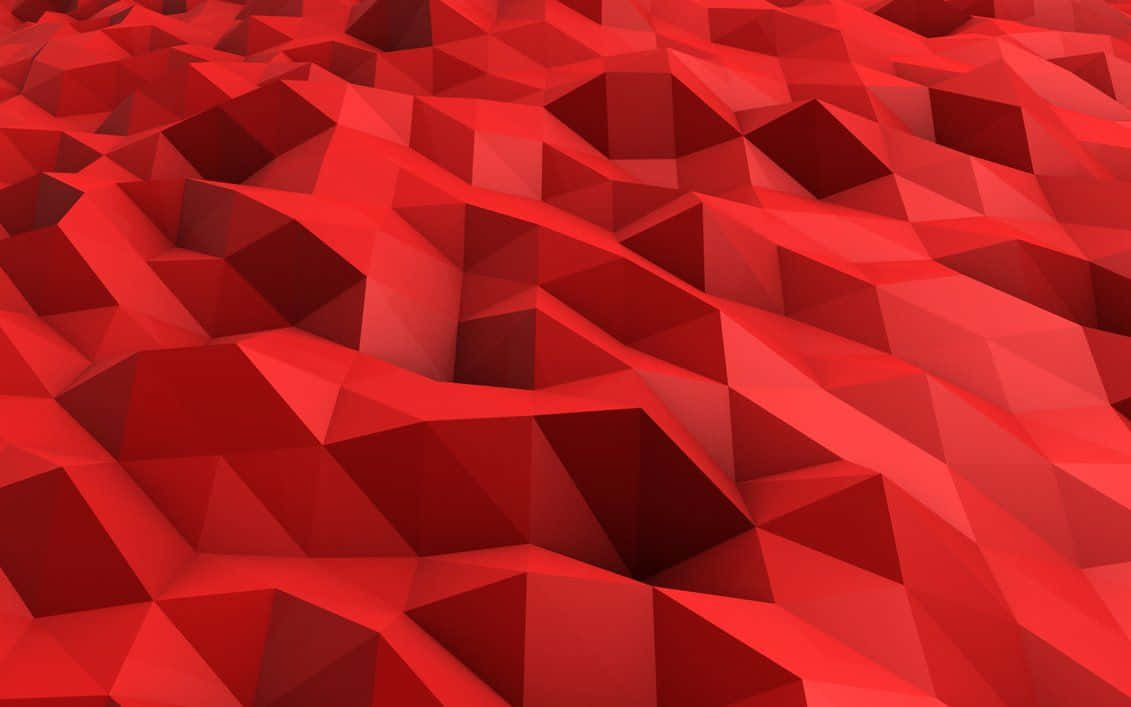 Red Abstract 桌布 壁紙 — 充滿活力的紅色低多邊形幾何表面，帶有銳利的三角形切面，營造出動態的紋理景觀。