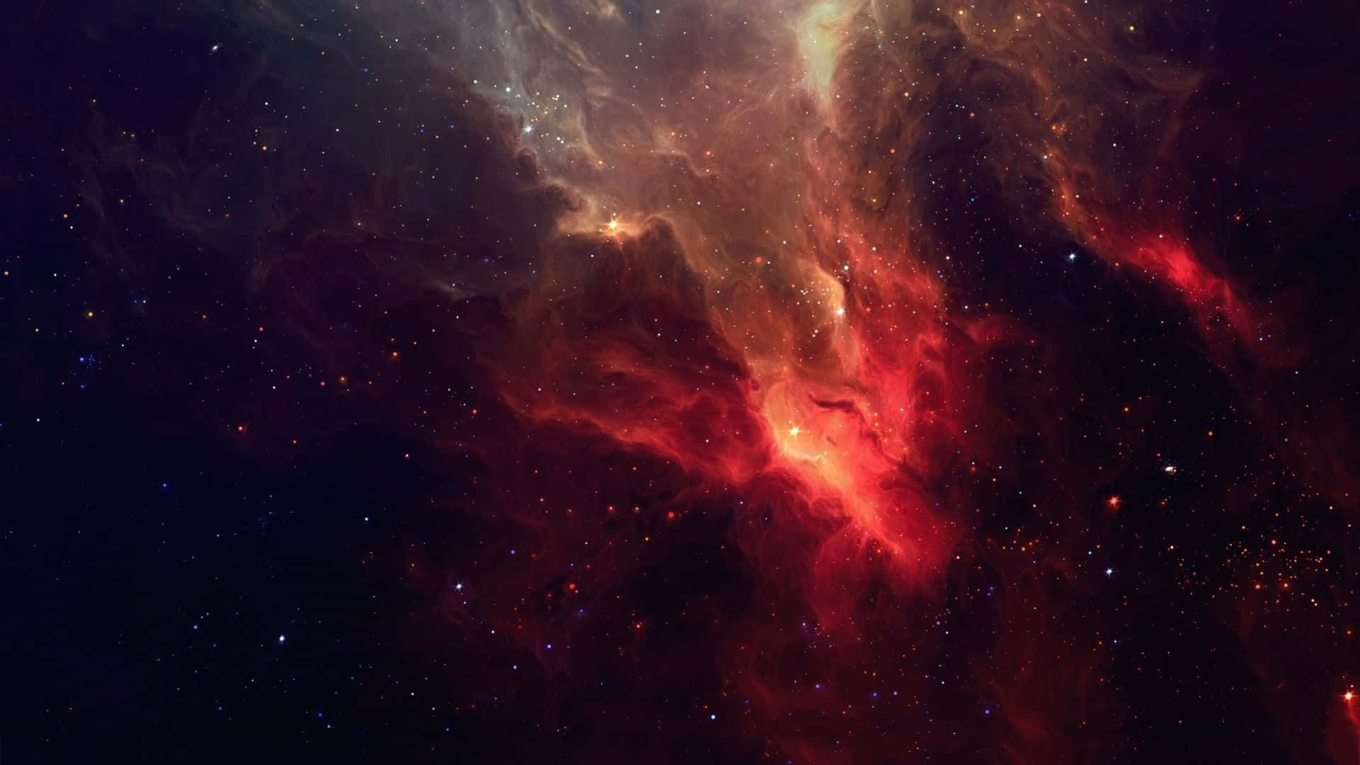 Red Space 桌布 壁紙 — 充滿活力的紅色和橙色宇宙雲在深空星雲中無數恆星之間旋轉。