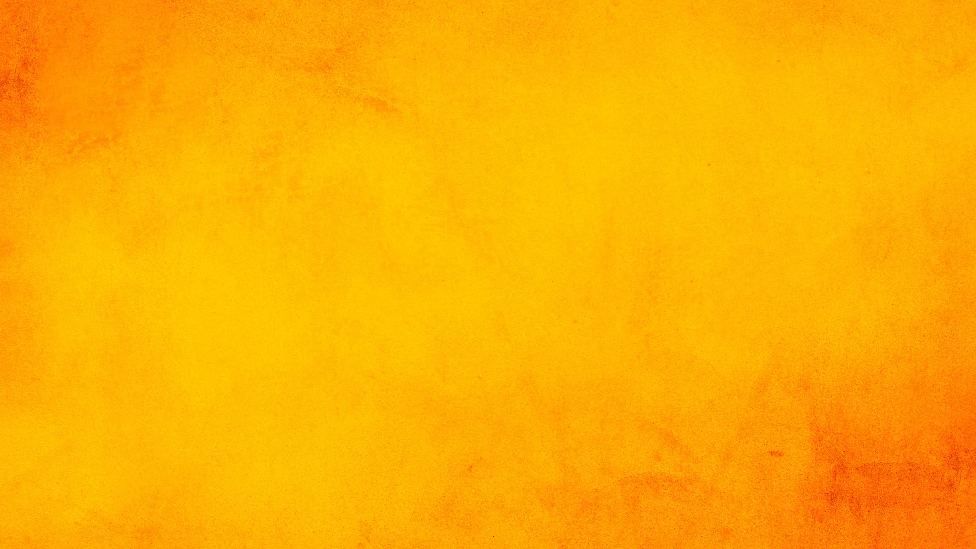 Yellow Grunge 桌布 壁紙 — 充滿活力的紋理橙色漸變背景，色調有細微變化，表面帶有顆粒感。