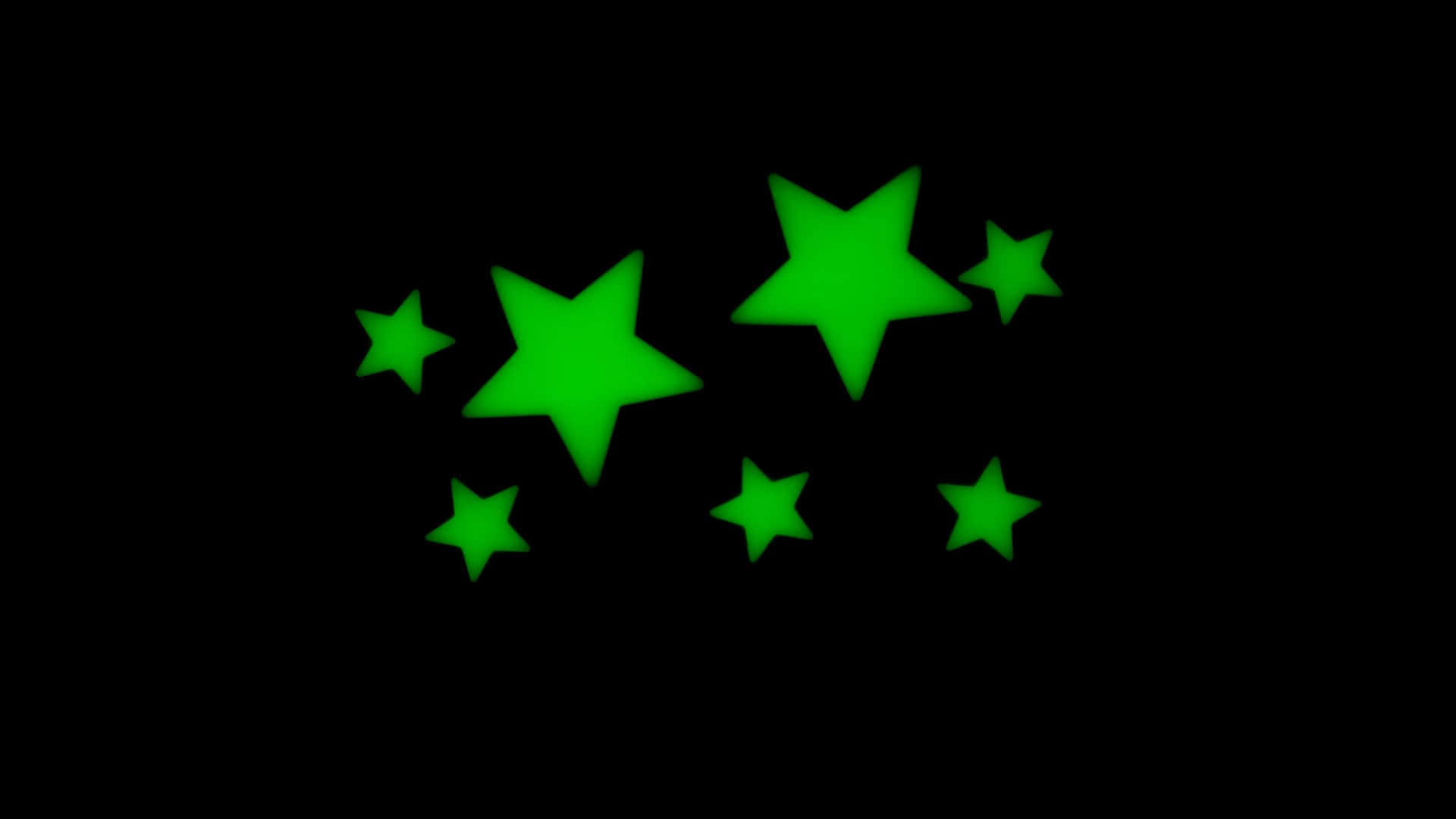 Glow In The Dark 桌布 壁紙 — 充滿活力的綠色發光星星漂浮在漆黑的背景上，營造出神奇的宇宙效果。