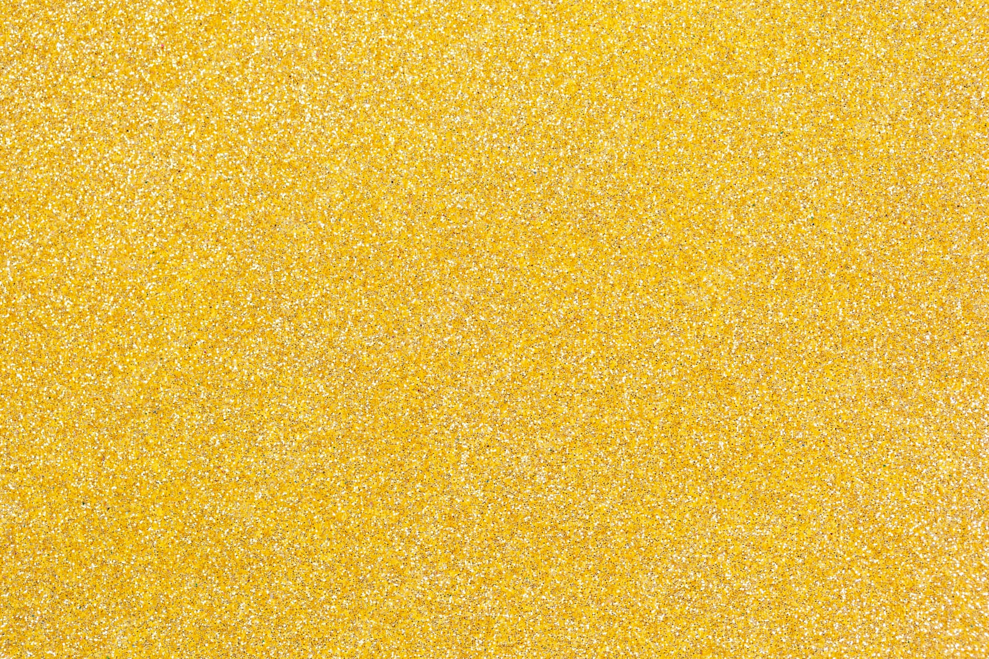 Yellow Glitter 桌布 壁紙 — 充滿活力的黃色閃粉紋理，帶有閃爍的銀色碎片，營造出閃閃發光的抽象表面。