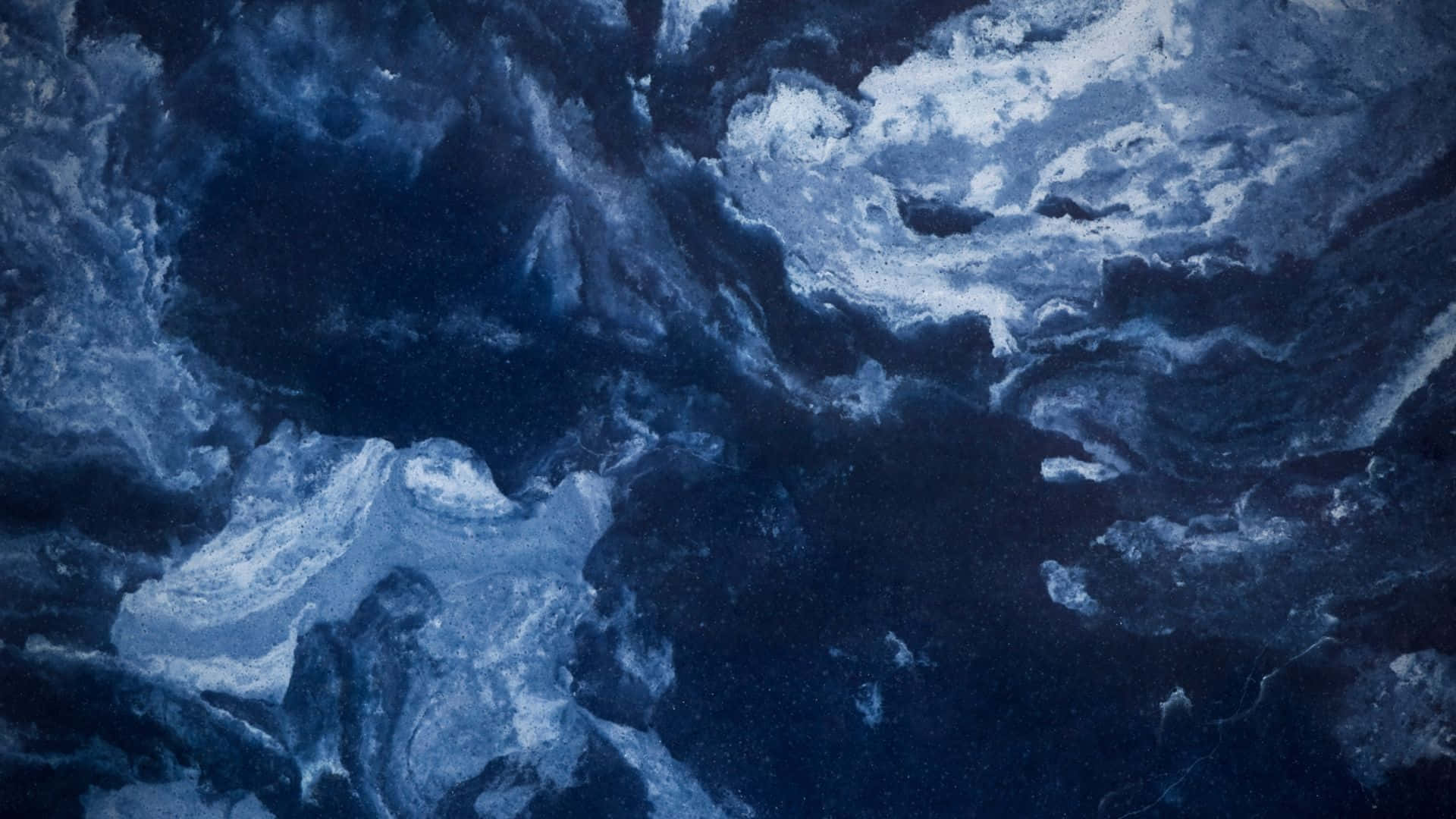 藍色和白色的漩渦抽象圖案，類似海浪或宇宙雲。