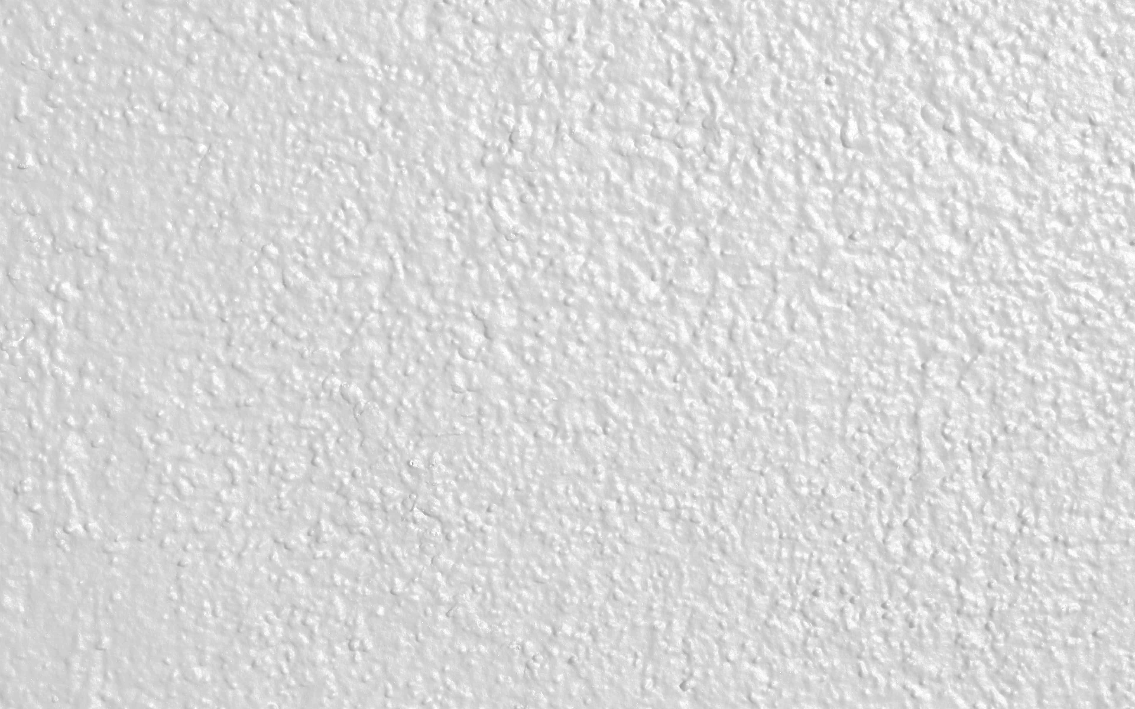 White HD 桌布 壁紙 — 光滑白色灰泥牆的特寫，帶有細微紋理和均勻照明。