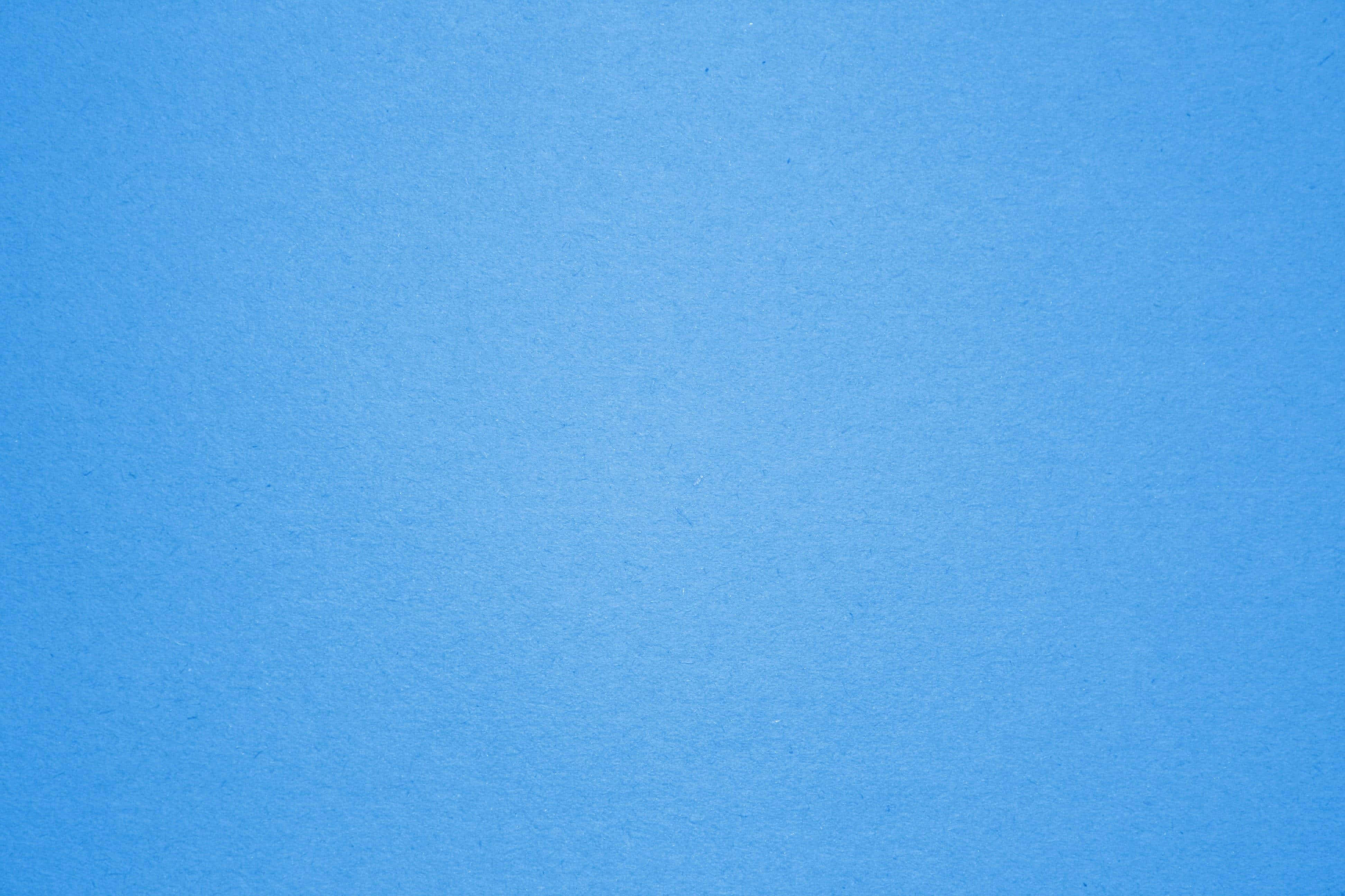 Blue Desktop 桌布 壁紙 — 光滑紋理藍色紙張表面，色調有細微變化，並帶有精細顆粒細節。