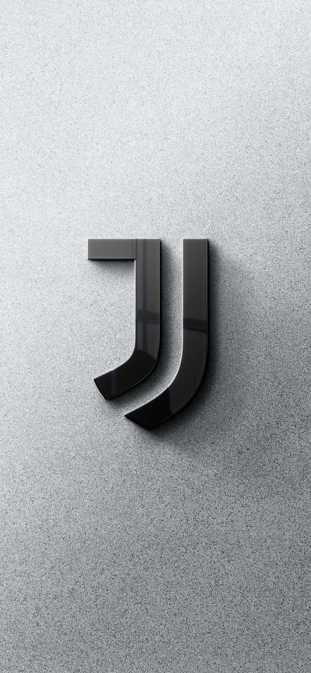 Juventus 桌布 壁紙 — 光滑黑色祖雲達斯標誌，帶有光澤飾面，在紋理灰色混凝土牆上投下柔和陰影。