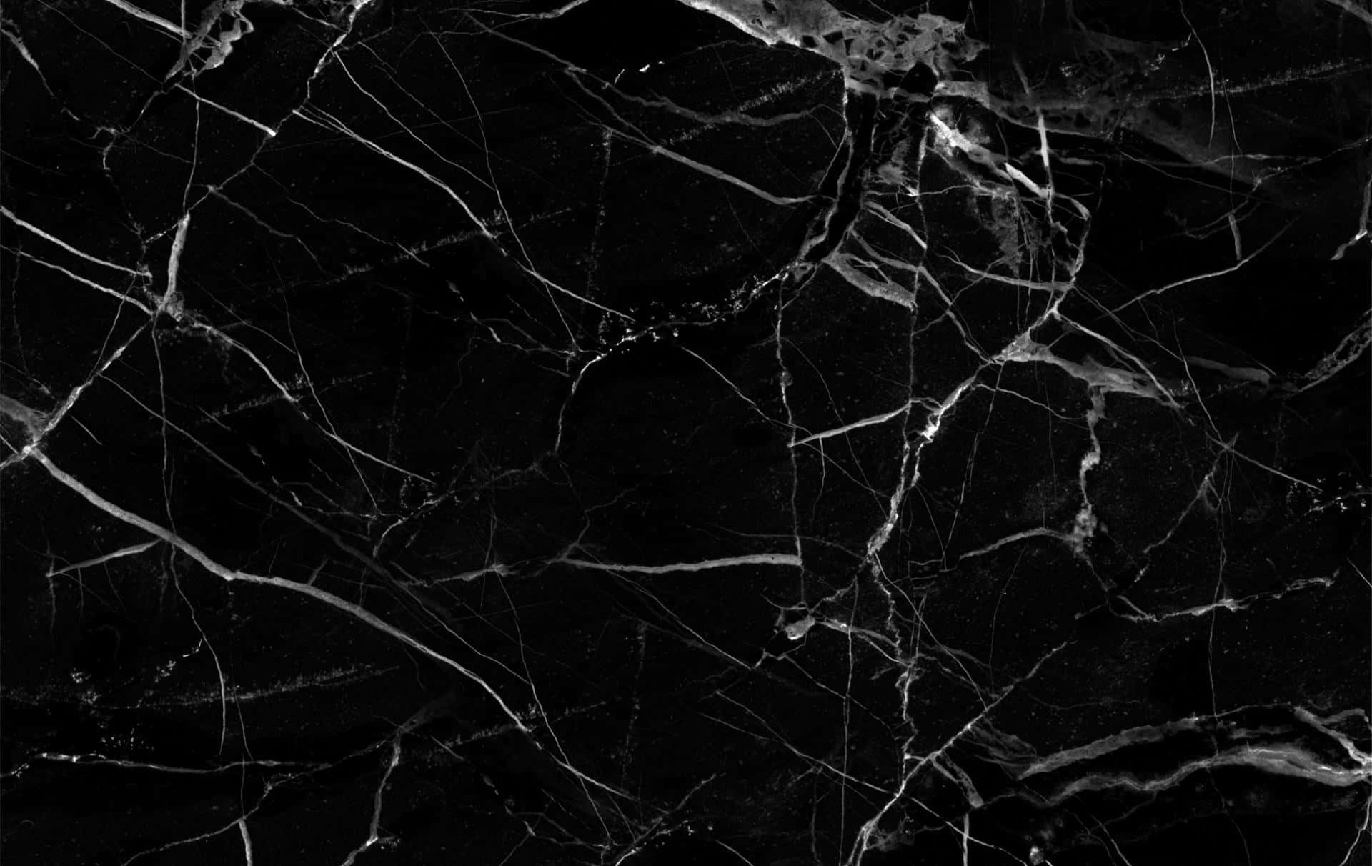 Aesthetic Marble 桌布 壁紙 — 光澤黑色大理石的特寫，帶有複雜的白色紋理，營造出奢華而戲劇性的質感。