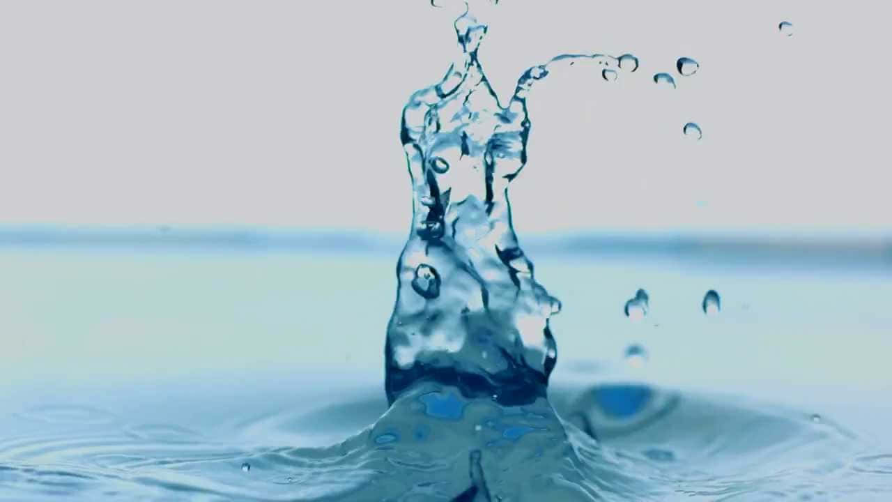 光線中優雅閃耀的水紋 壁紙 — 清澈的藍色水花動態地向上噴發，水滴懸浮在半空中，背景是柔和的漸變色。