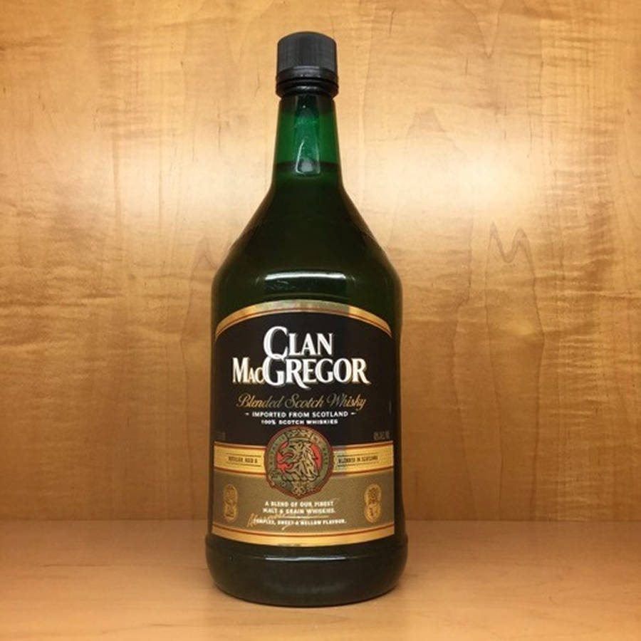 木質表面上有一瓶帶有 Clan MacGregor 標籤的綠色威士忌酒瓶。