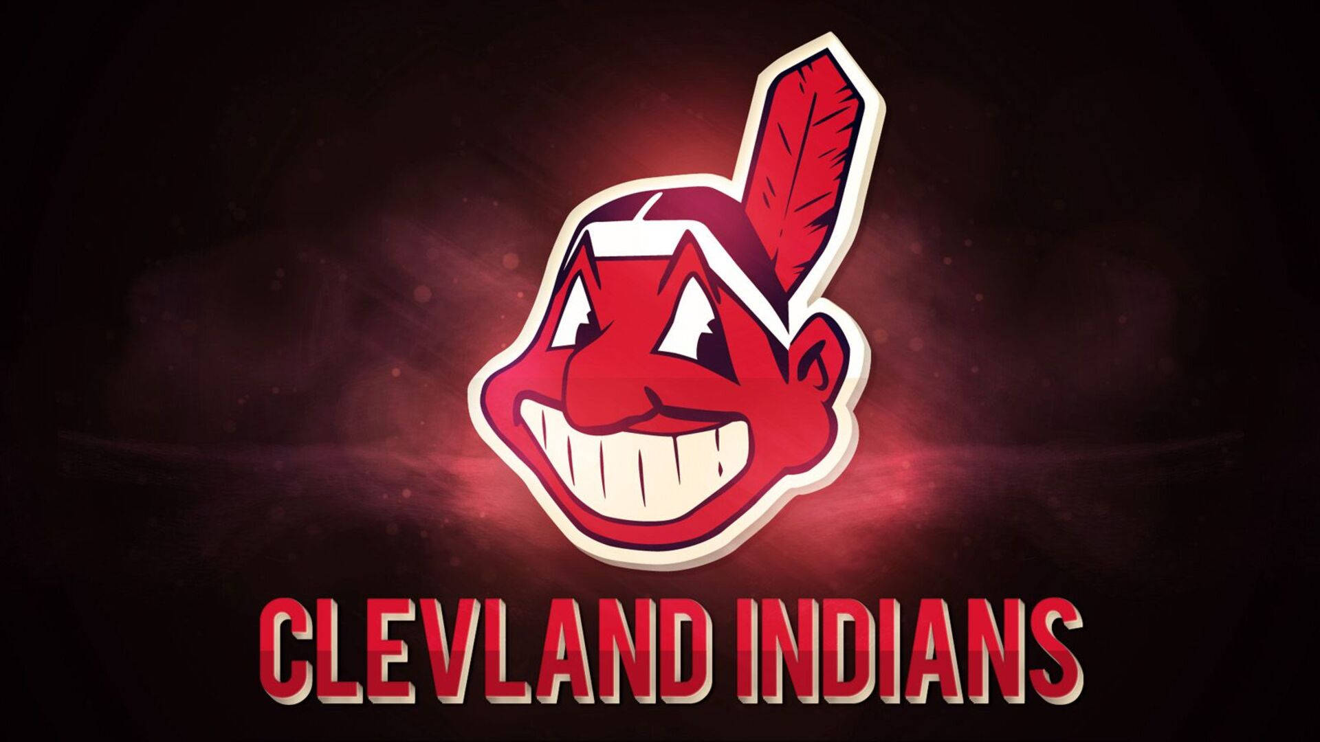 克里夫蘭印第安人隊霓虹粉 Chief Wahoo 壁紙 — 一個大膽的紅色卡通美洲原住民吉祥物頭像，帶有羽毛和寬闊的笑容，在黑暗煙霧背景上發光，下方有 'CLEVELAND INDIANS' 文字。