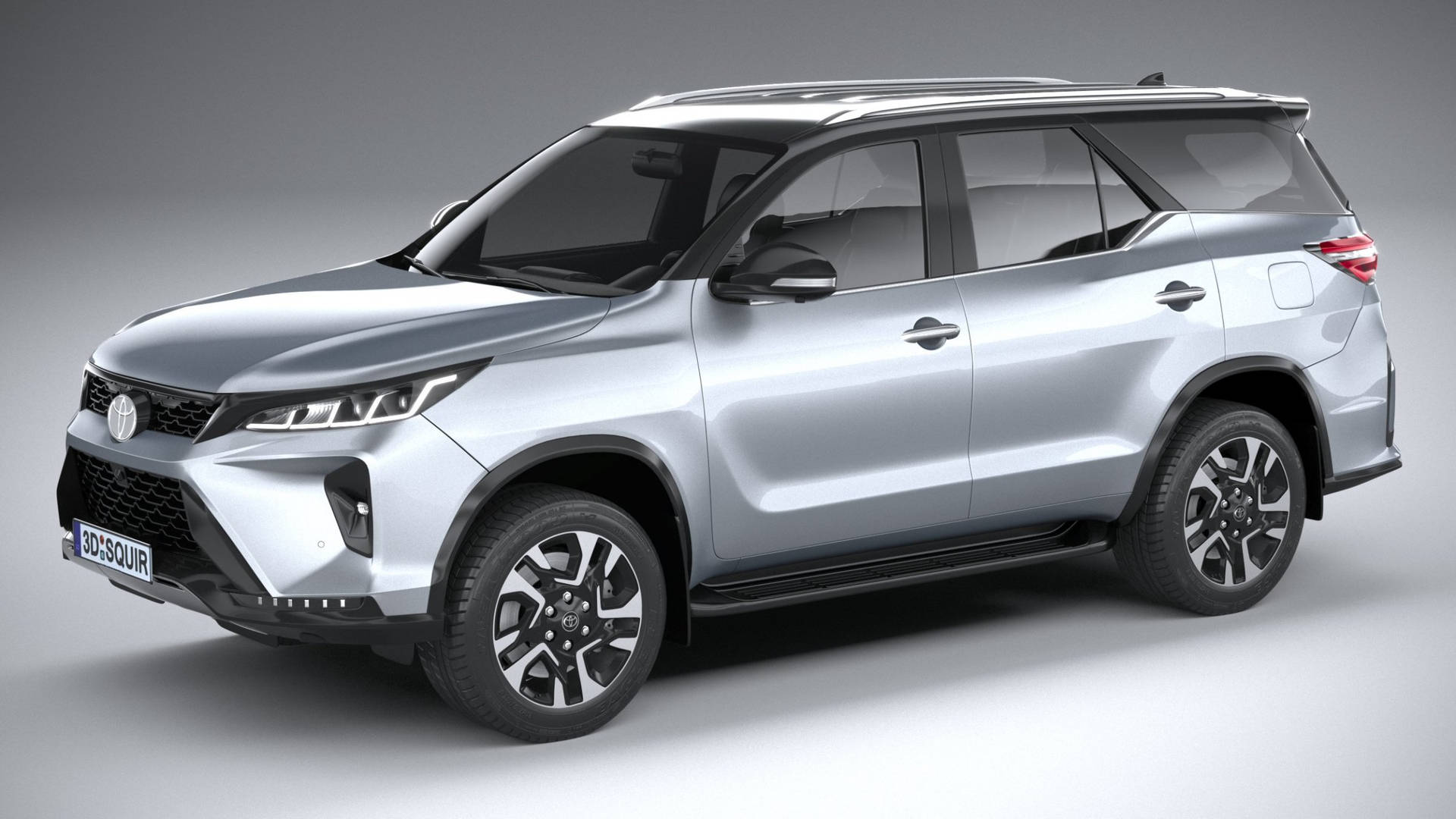 銀色SUV，黑色飾邊和時尚輪轂，在工作室燈光下。