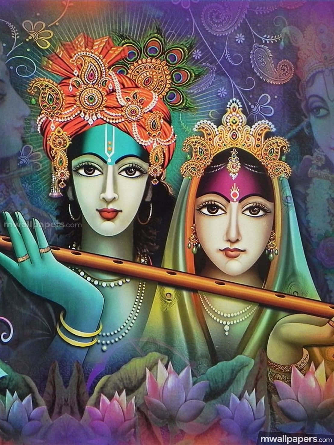 Radha Krishna 桌布 壁紙 — 兩位神聖人物裝飾著華麗的皇冠和珠寶，在發光的蓮花和旋轉的佩斯利圖案中吹奏長笛。