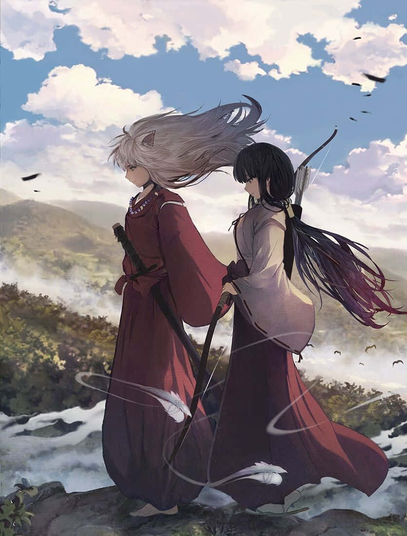Inuyasha And Kikyo 桌布 壁紙 — 兩位身穿飄逸紅袍的動漫戰士，在陰雲密布的天空下，背對背站在俯瞰迷霧山谷的懸崖上。