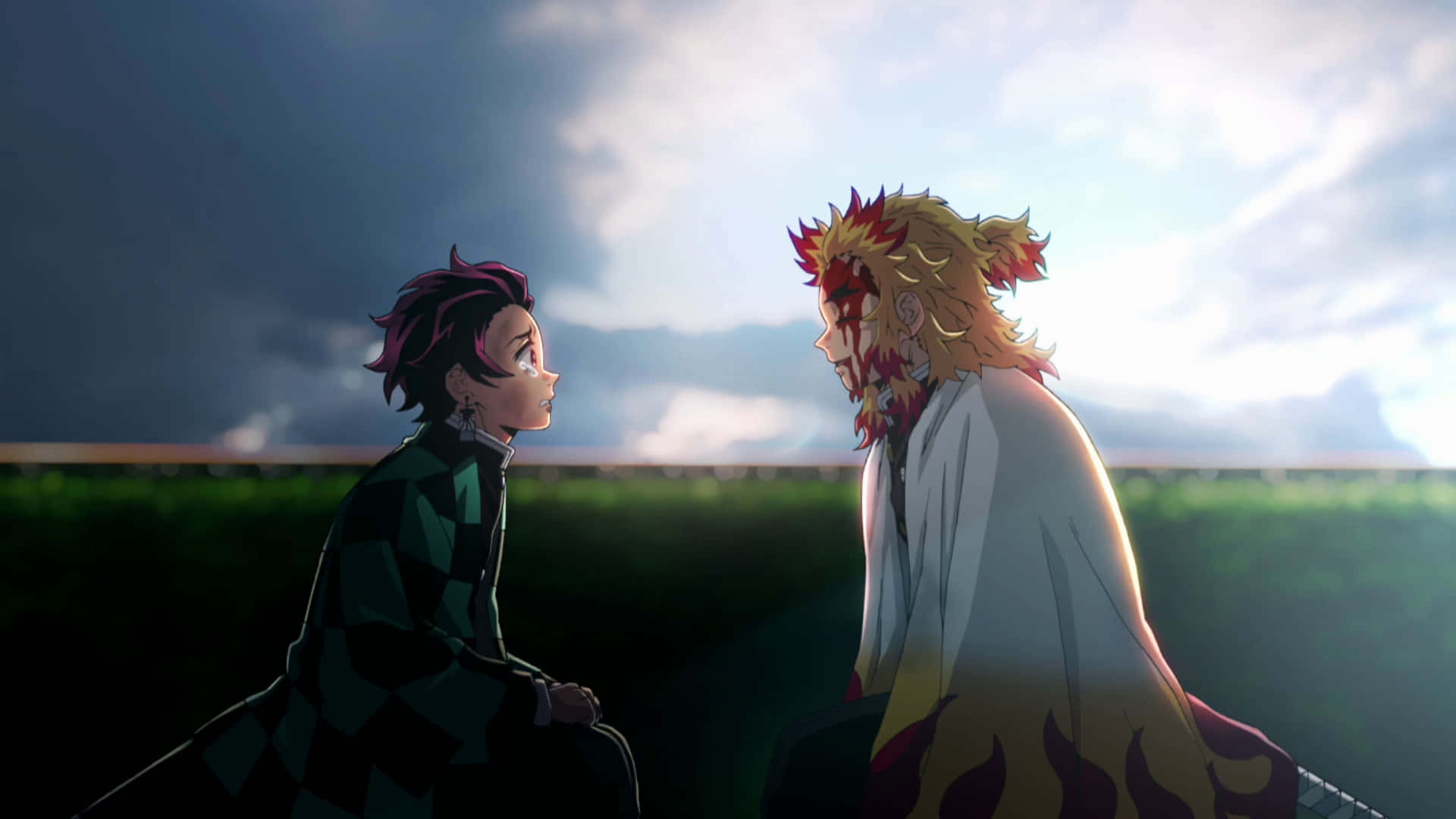 Rengoku And Tanjiro 桌布 壁紙 — 兩個動漫角色在多雲的天空下，背光中於戲劇性的戶外場景中面對面。