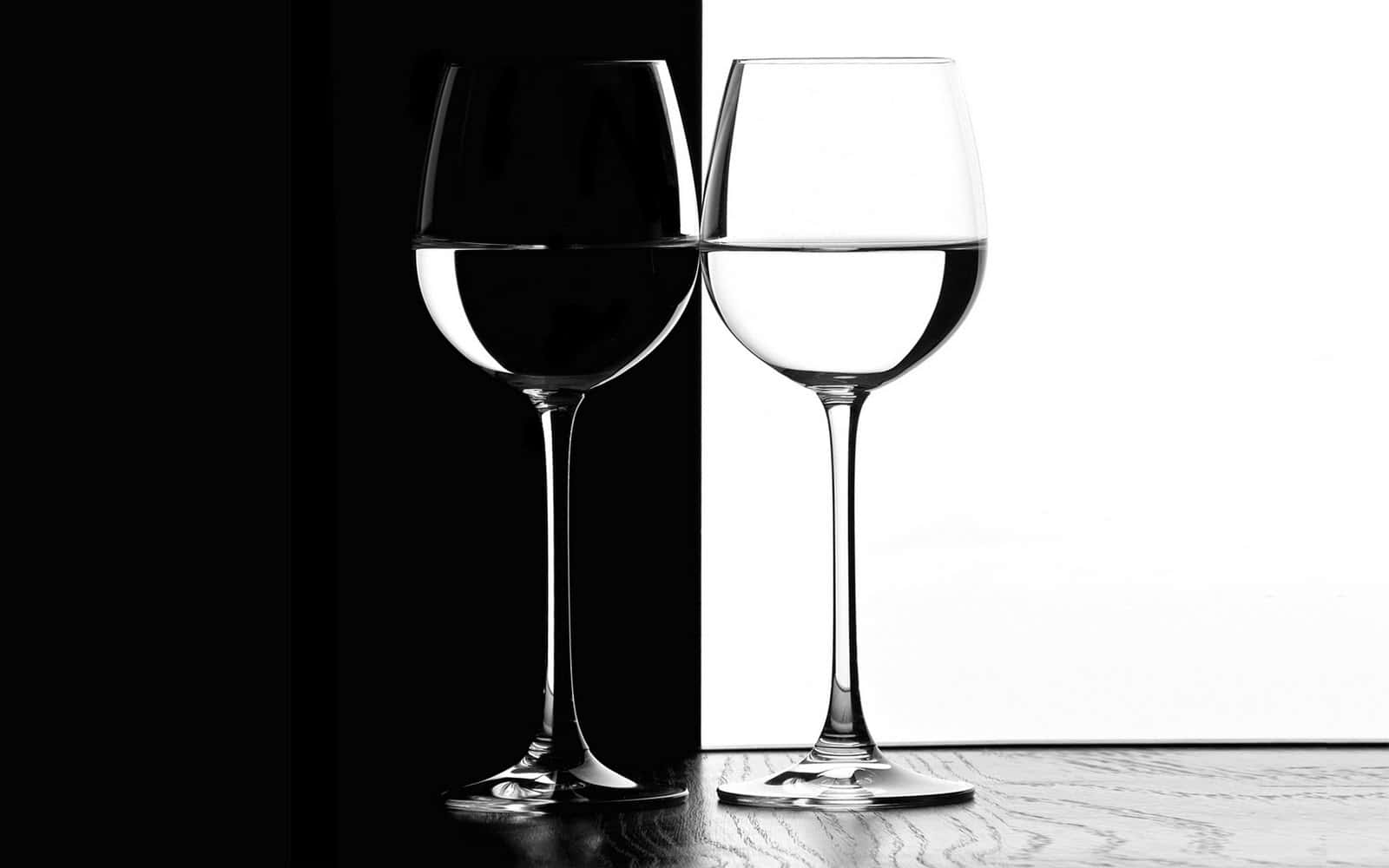 Contrast 桌布 壁紙 — 兩個半滿液體的酒杯，在分割的背景前呈現強烈的黑白對比。