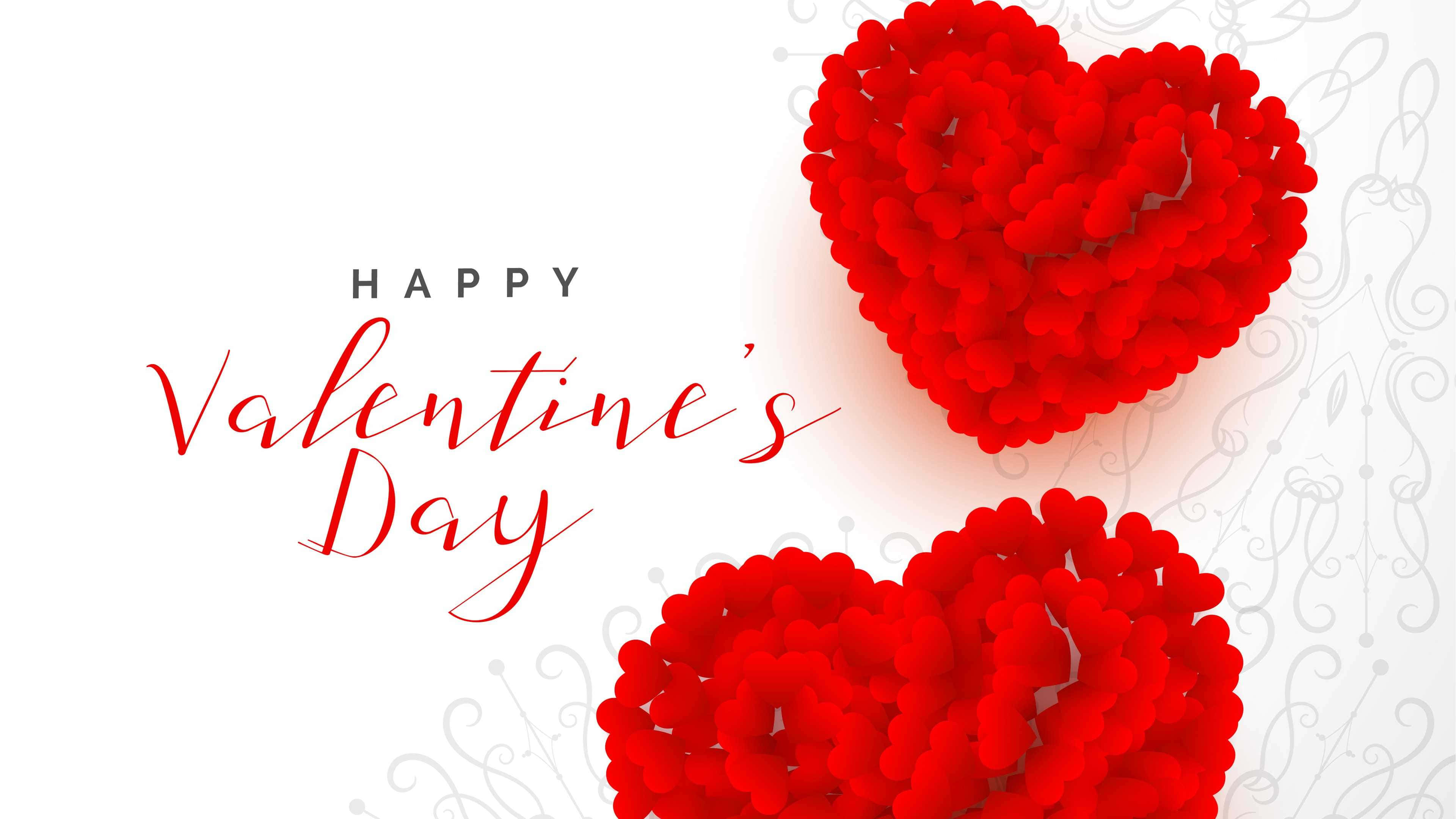 Happy Valentines Day 桌布 壁紙 — 兩個由小球體組成的鮮紅色心形簇，漂浮在帶有微妙灰色漩渦的白色背景上，旁邊是優雅的草書情人節文字。