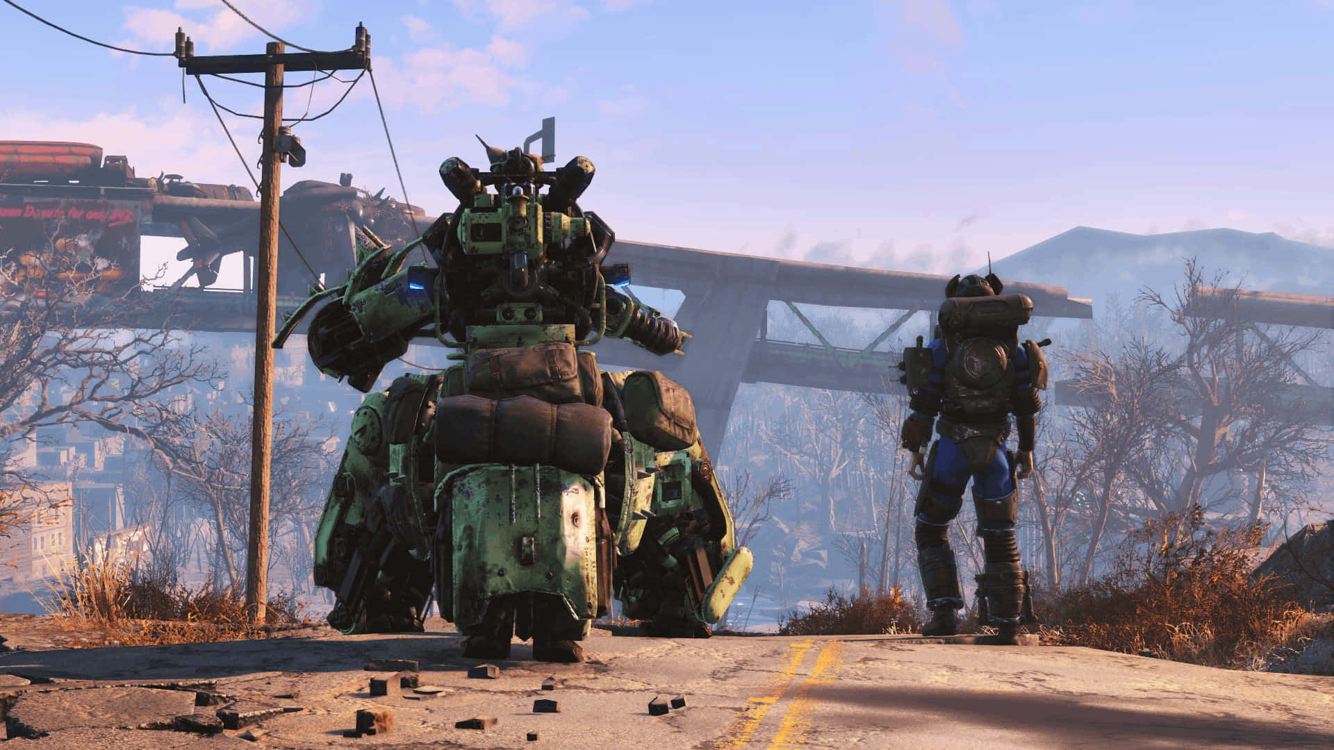 Fallout 4 Wasteland 桌布 壁紙 — 兩個身穿裝甲的身影站在末日後荒原上一條破裂的道路上，周圍有斷橋和光禿禿的樹木，天空朦朧。
