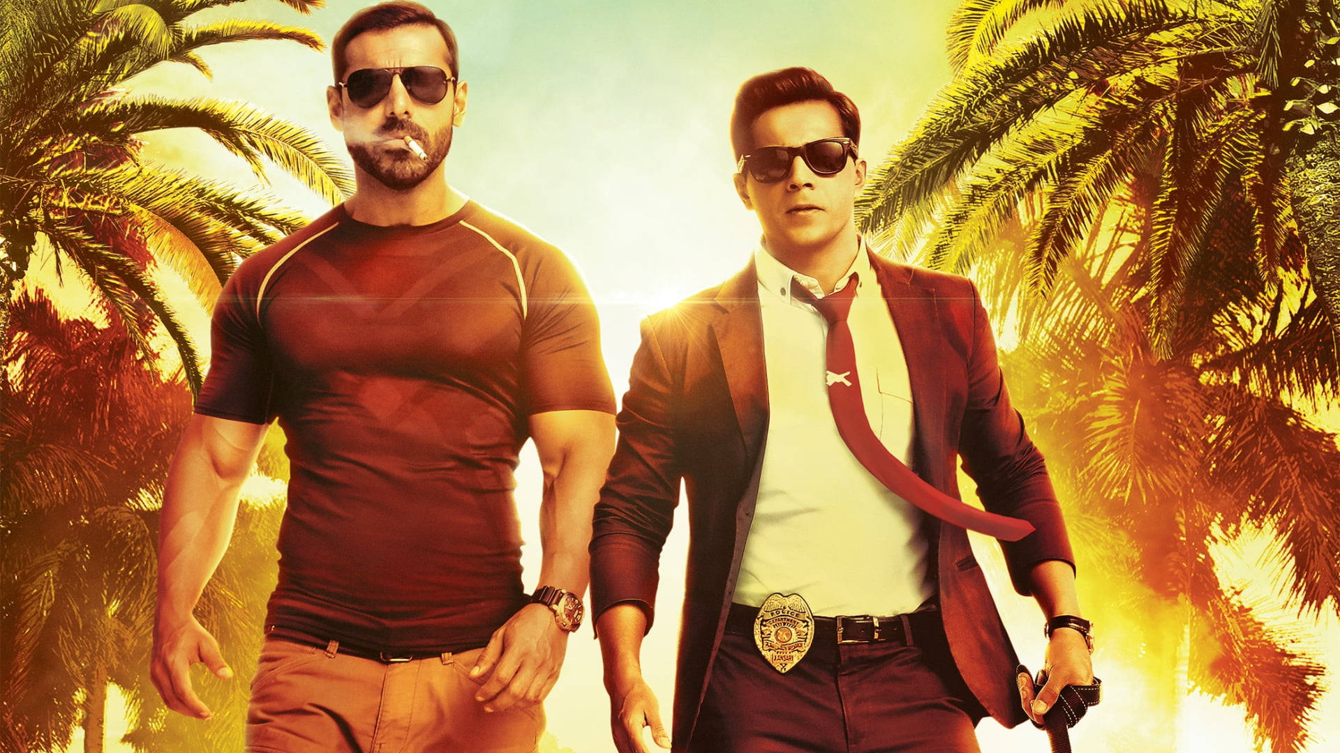 John Abraham 桌布 壁紙 — 兩名肌肉發達的男子戴著太陽眼鏡，自信地站在棕櫚樹環繞的熾熱日落背景下。