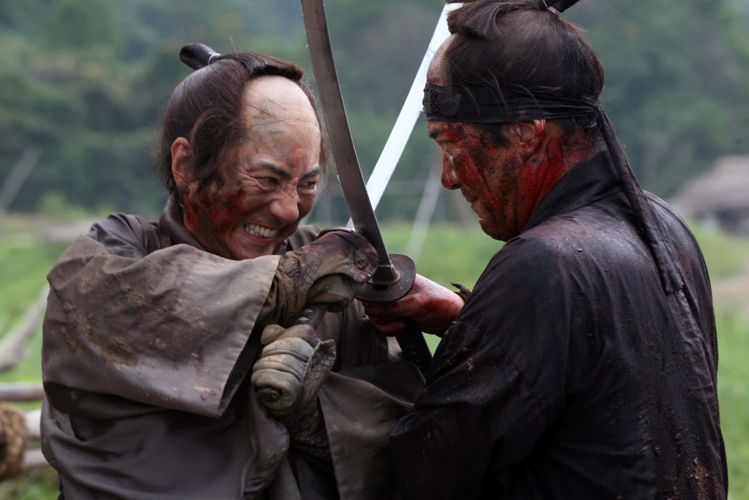 Samurai Movies 桌布 壁紙 — 兩名血跡斑斑的武士在泥濘的田野中以激烈的表情交鋒。