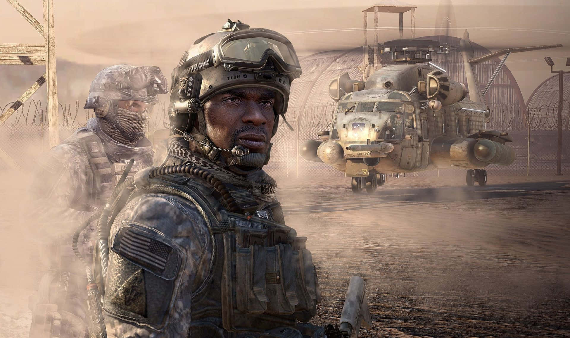 Call Of Duty Soldiers 桌布 壁紙 — 兩名身穿沙漠迷彩服的士兵站在一個圍欄區域內，面前是一架揚起灰塵的軍用直升機。