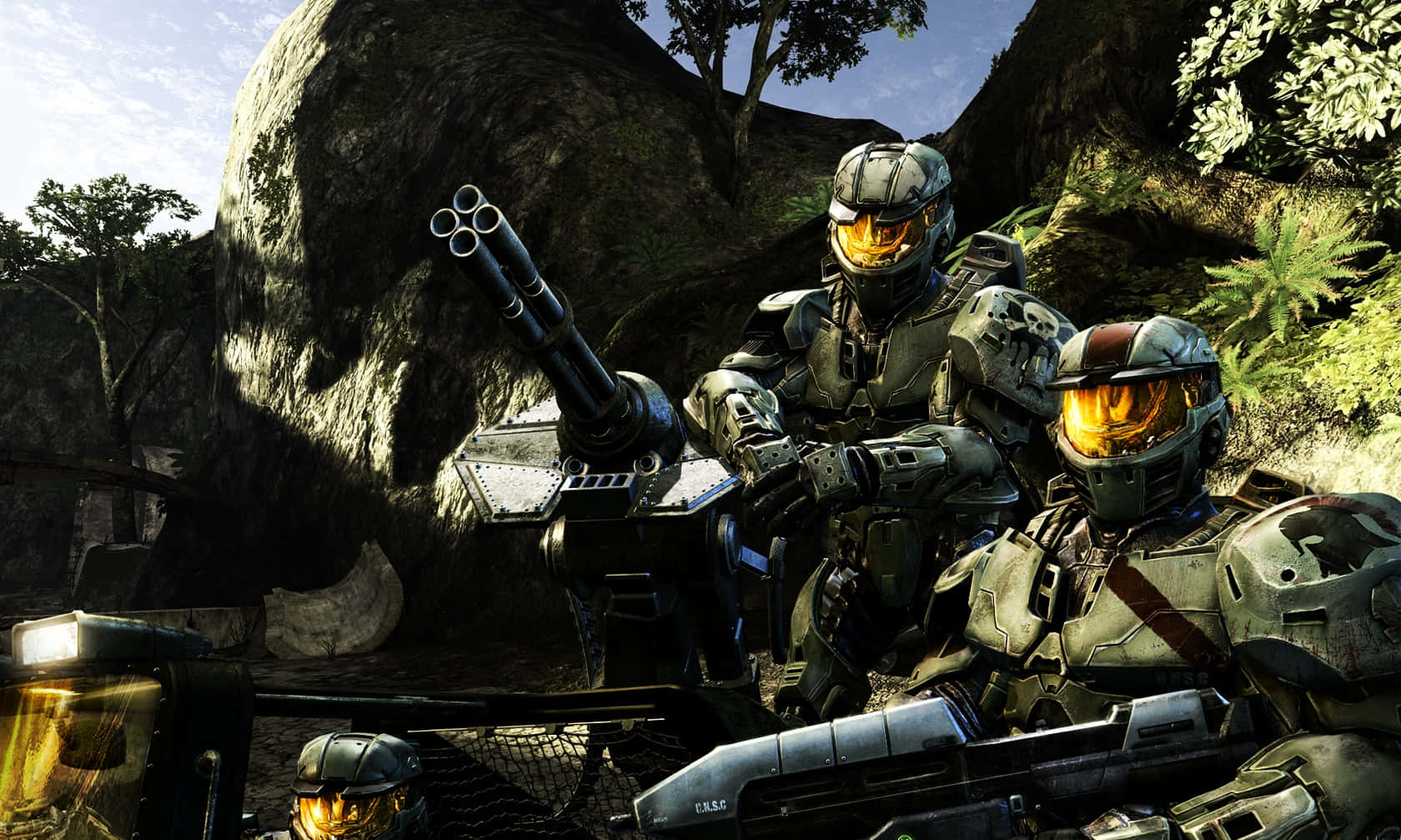 Halo Spartans 桌布 壁紙 — 兩名身穿裝甲、戴著橙色發光面罩的士兵在岩石叢林的空地中手持重型武器準備就緒。