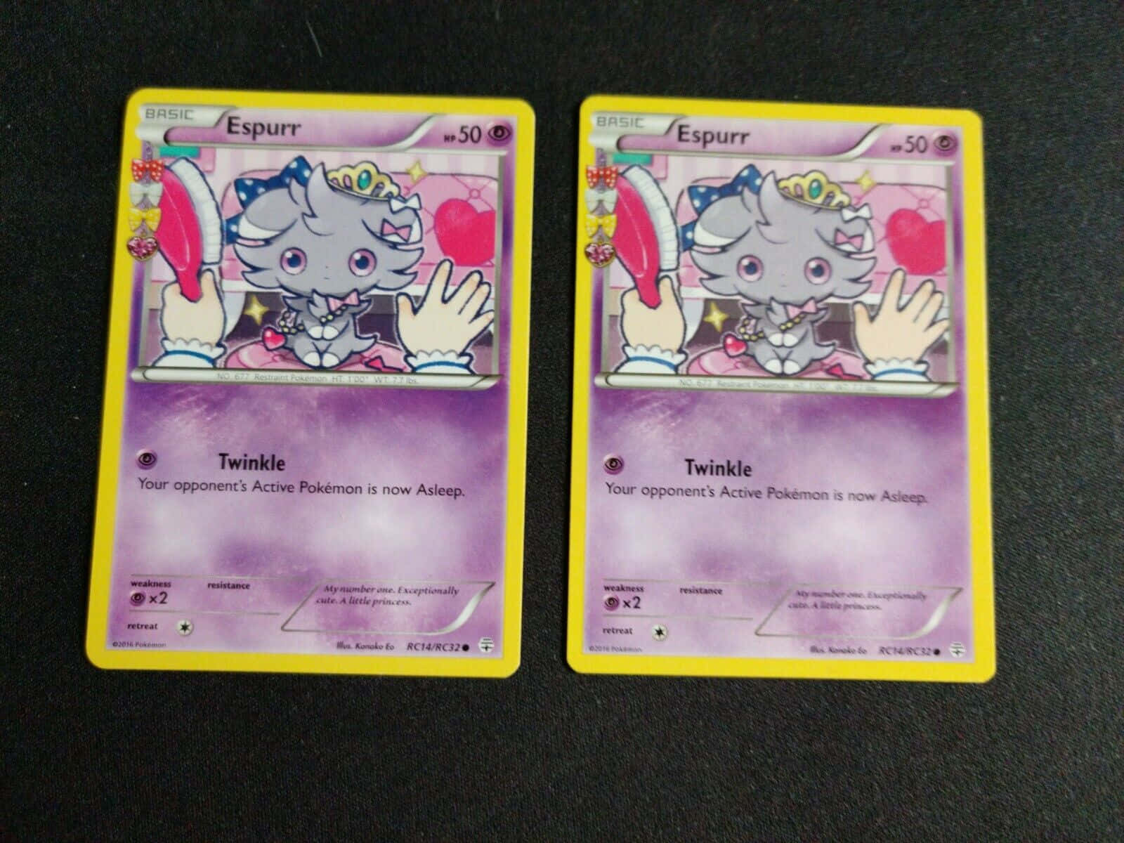 兩張相同的 Espurr 寶可夢交換卡牌放在深色背景上。