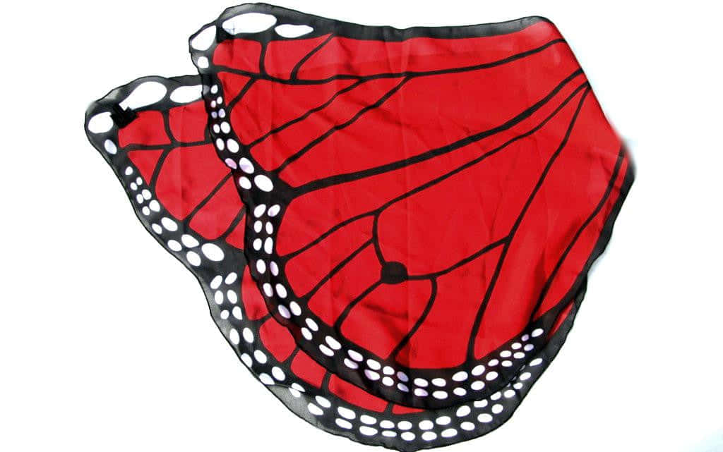 Butterfly Wing Dress 桌布 壁紙 — 兩片鮮豔的紅色帝王蝶翅膀，帶有黑色脈絡和白色斑點，懸掛在純白背景上。