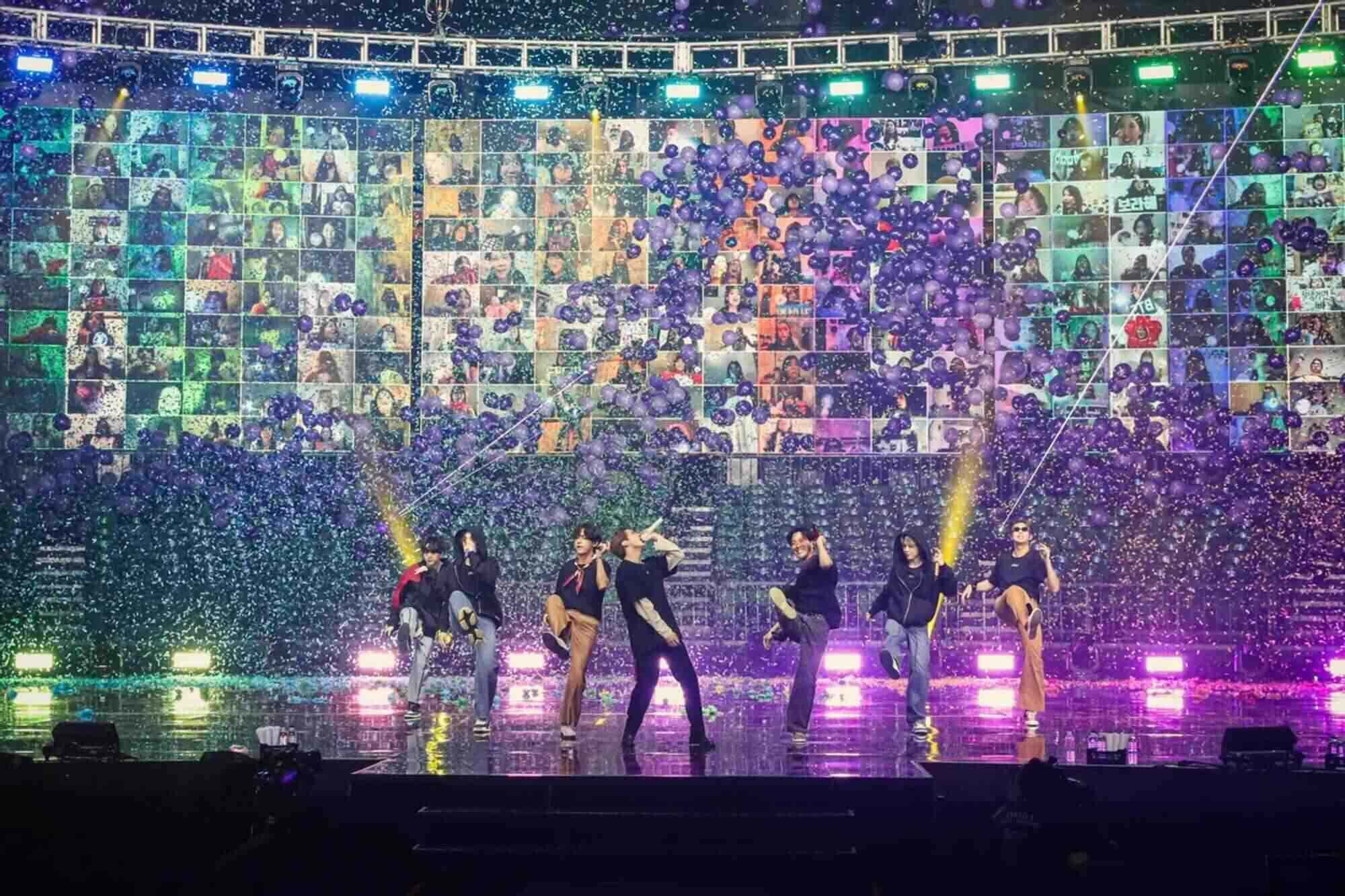 Bts Live 桌布 壁紙 — 六位表演者在濕滑的舞台上充滿活力地跳舞，紫色紙屑在鮮豔的舞台燈光下如雨般落下。