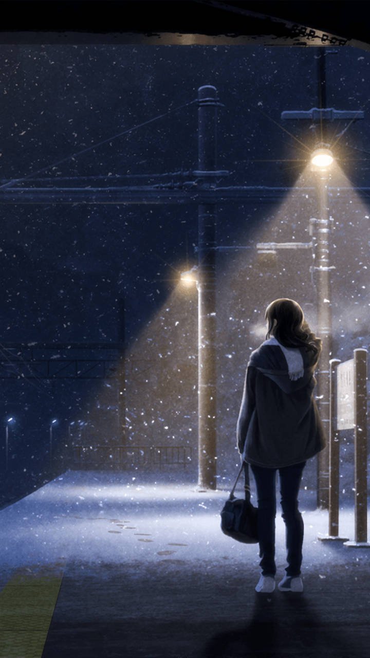 女人獨自站在雪夜的火車站，街燈下。