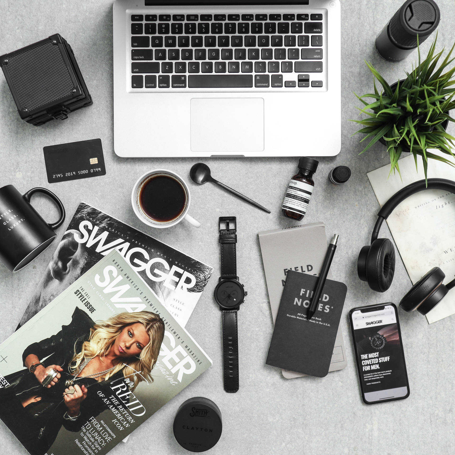 Minimalist desk setup with laptop coffee and tech gadgets