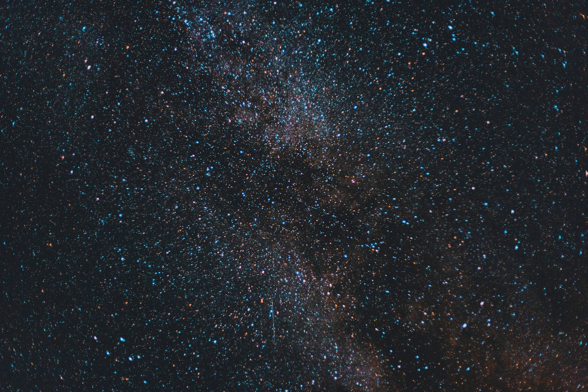 在黑暗的夜空中，銀河系帶有藍色和橙色的星星。